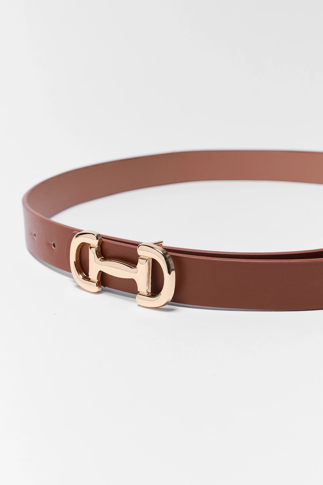 Brown belt with a gold buckle on a white background