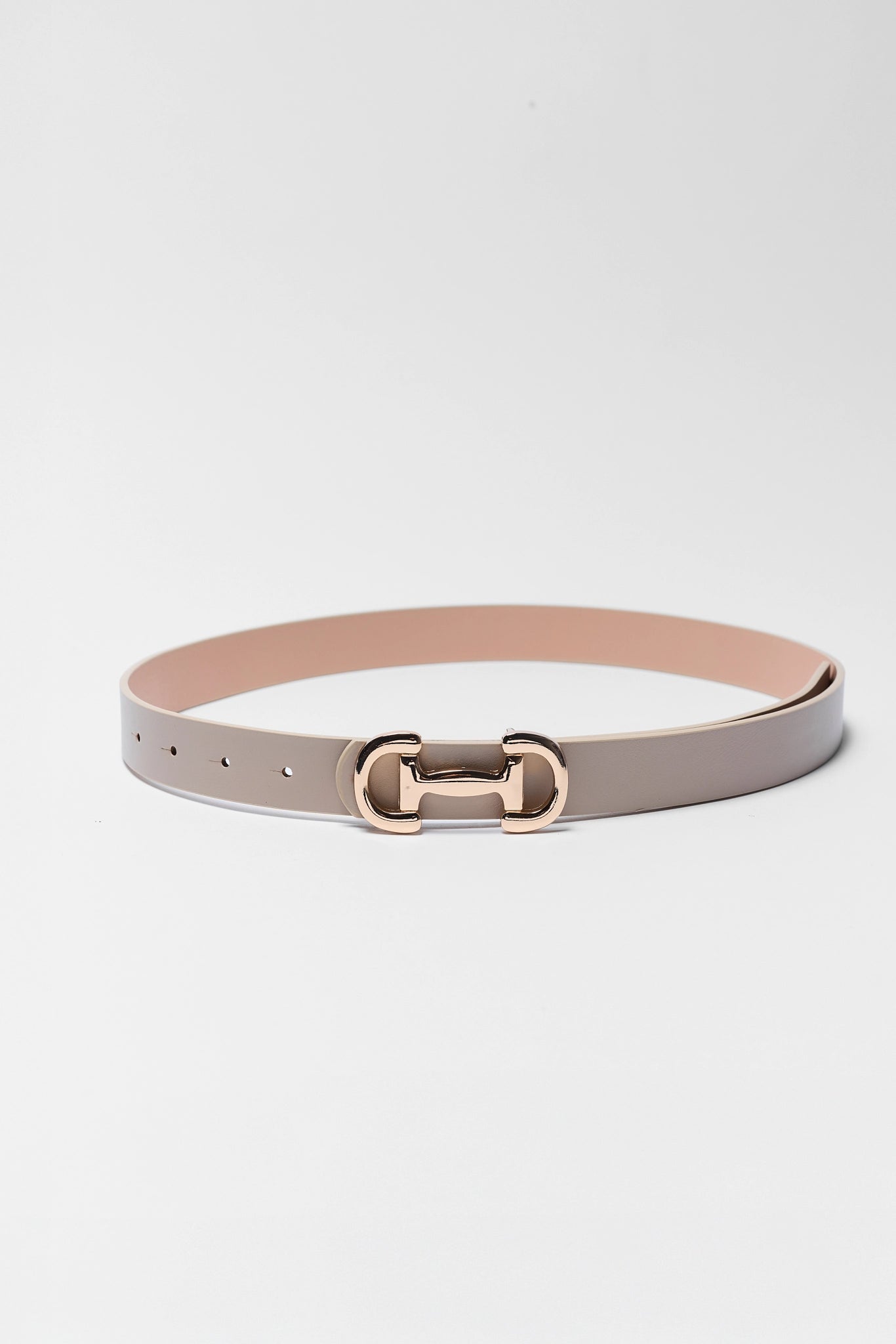 Belt with a rose gold buckle on a light gray background