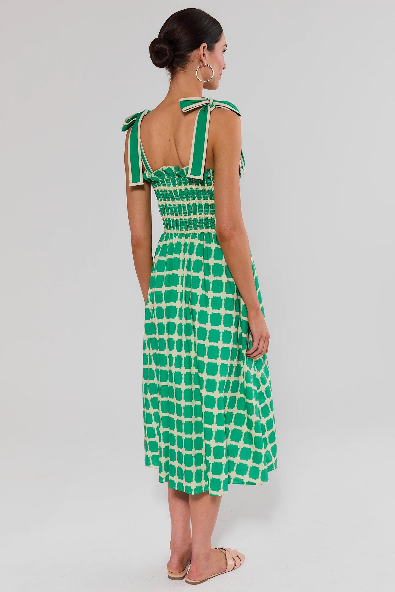 back shot woman wearing green talia dress on white background