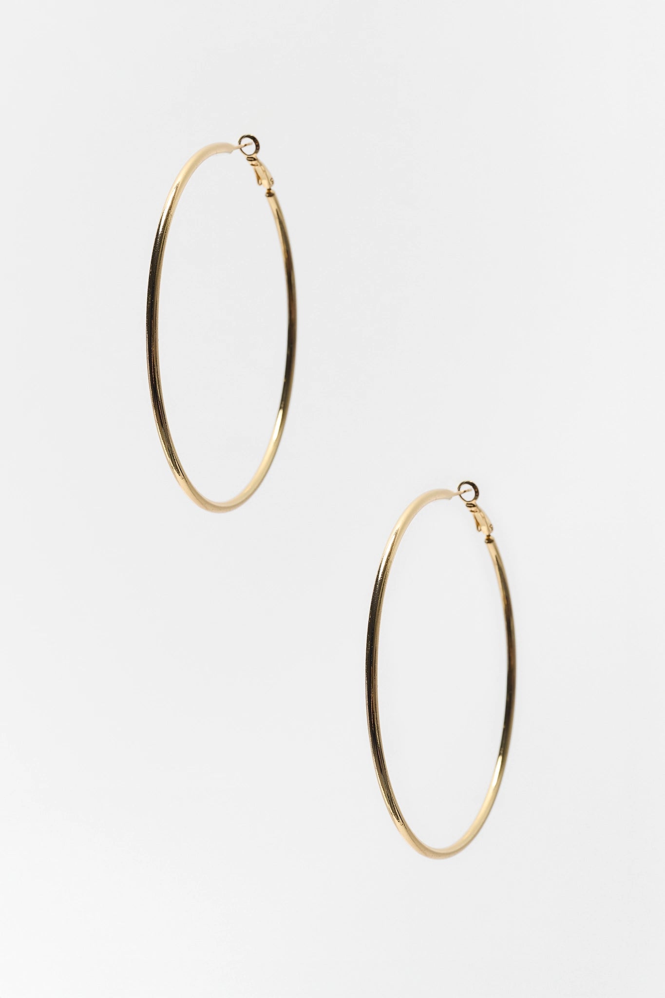 Gold hoop earrings on a white background