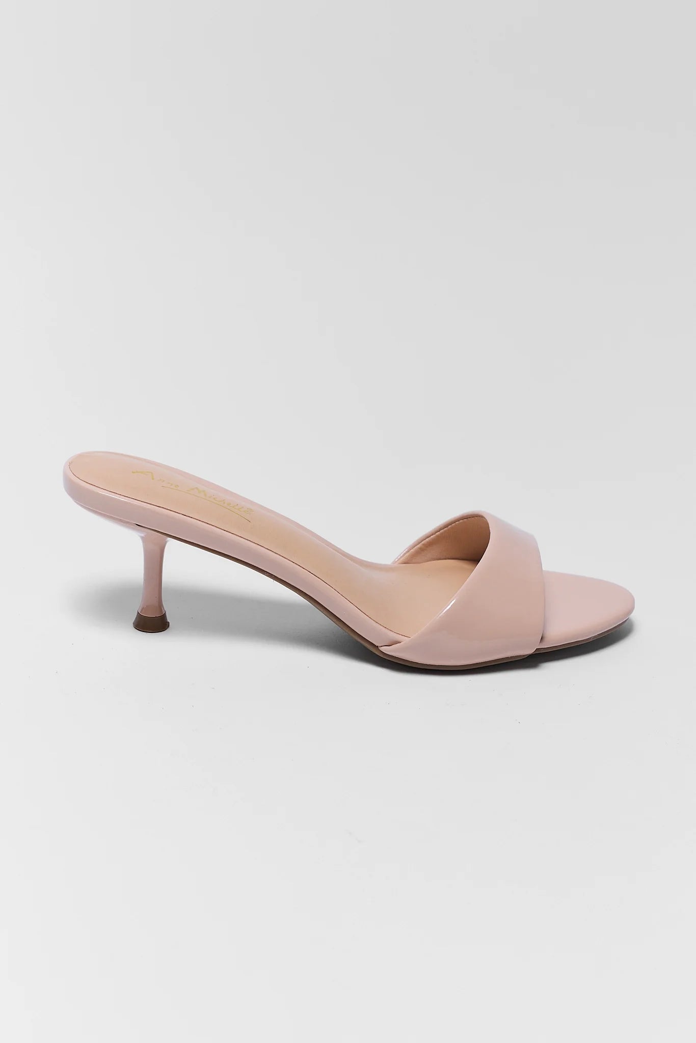 Pink high-heeled sandal on a white background