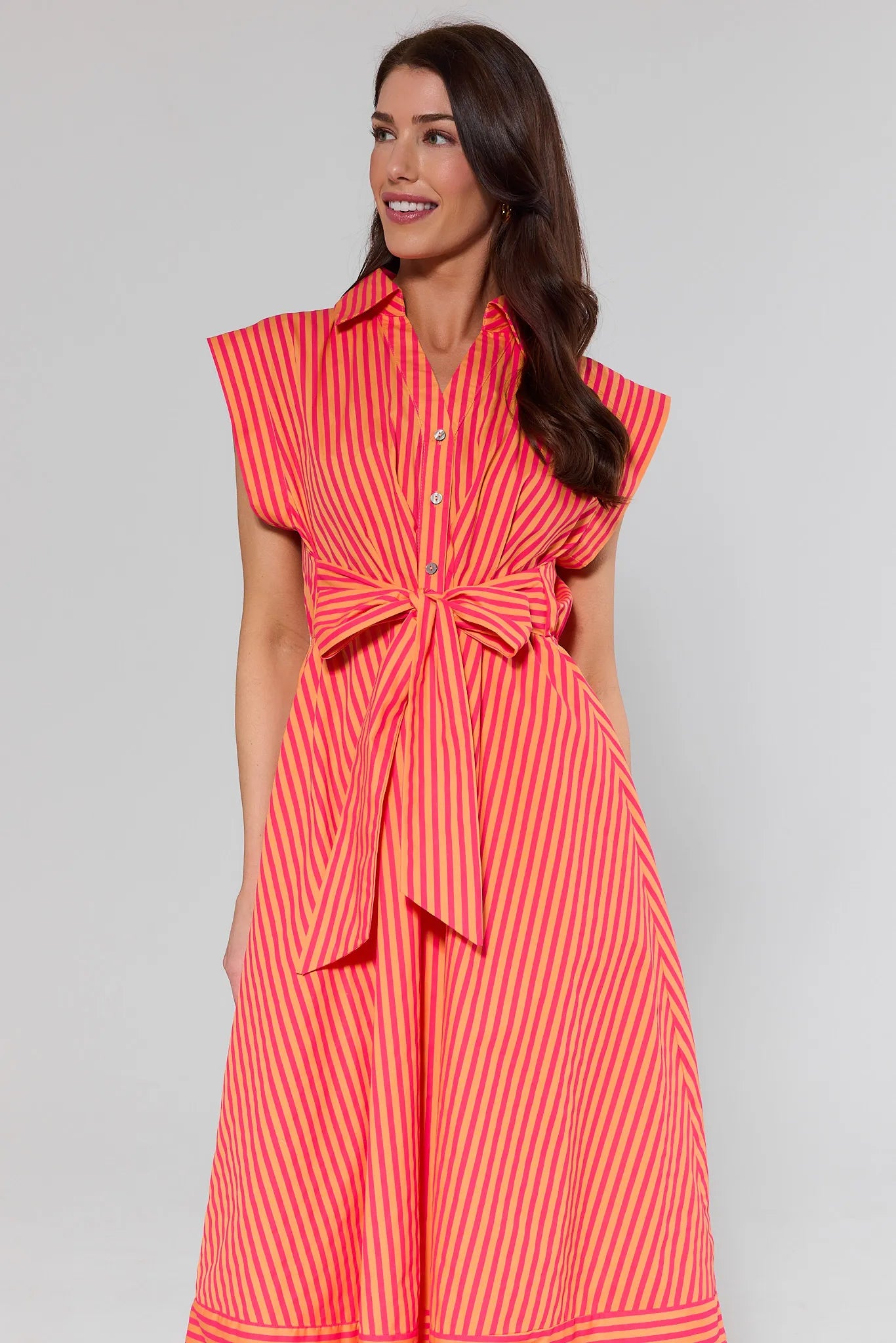 Woman wearing a red and white striped dress against a gray background