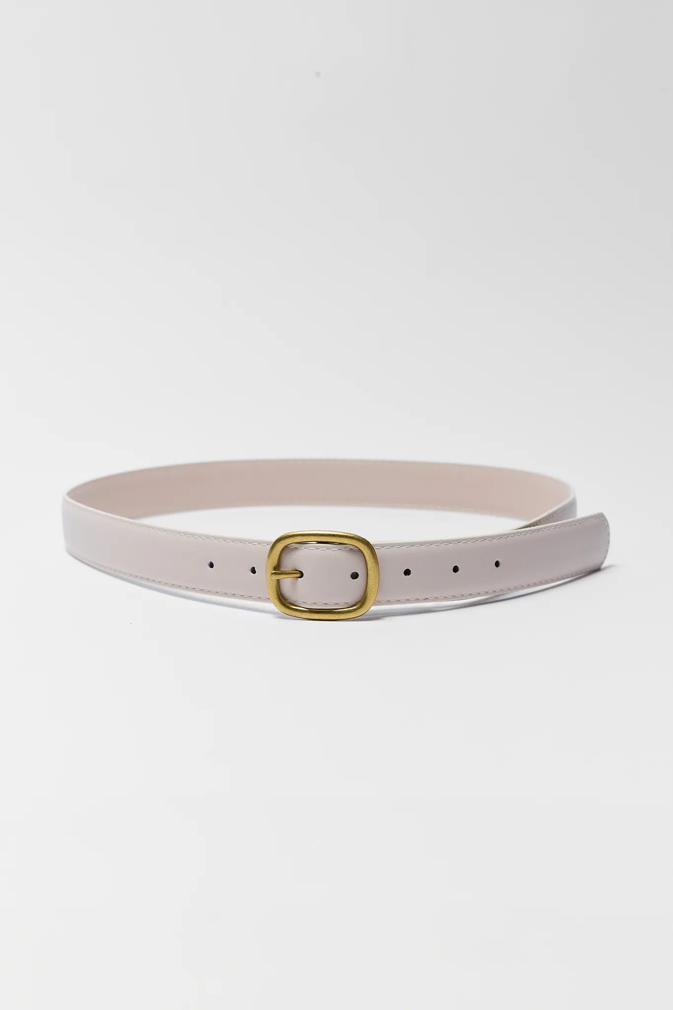 Light gray belt with a gold buckle on a light gray background
