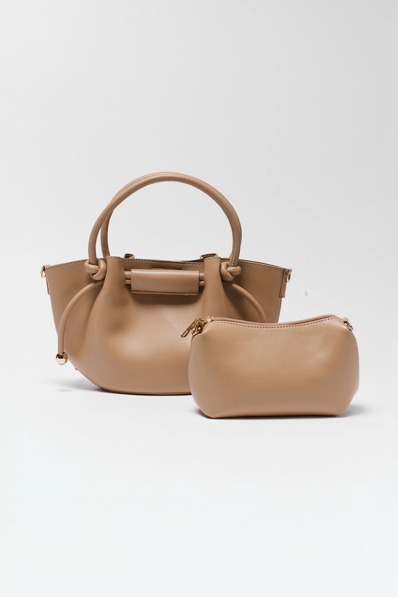 Beige handbag and matching pouch on a white background