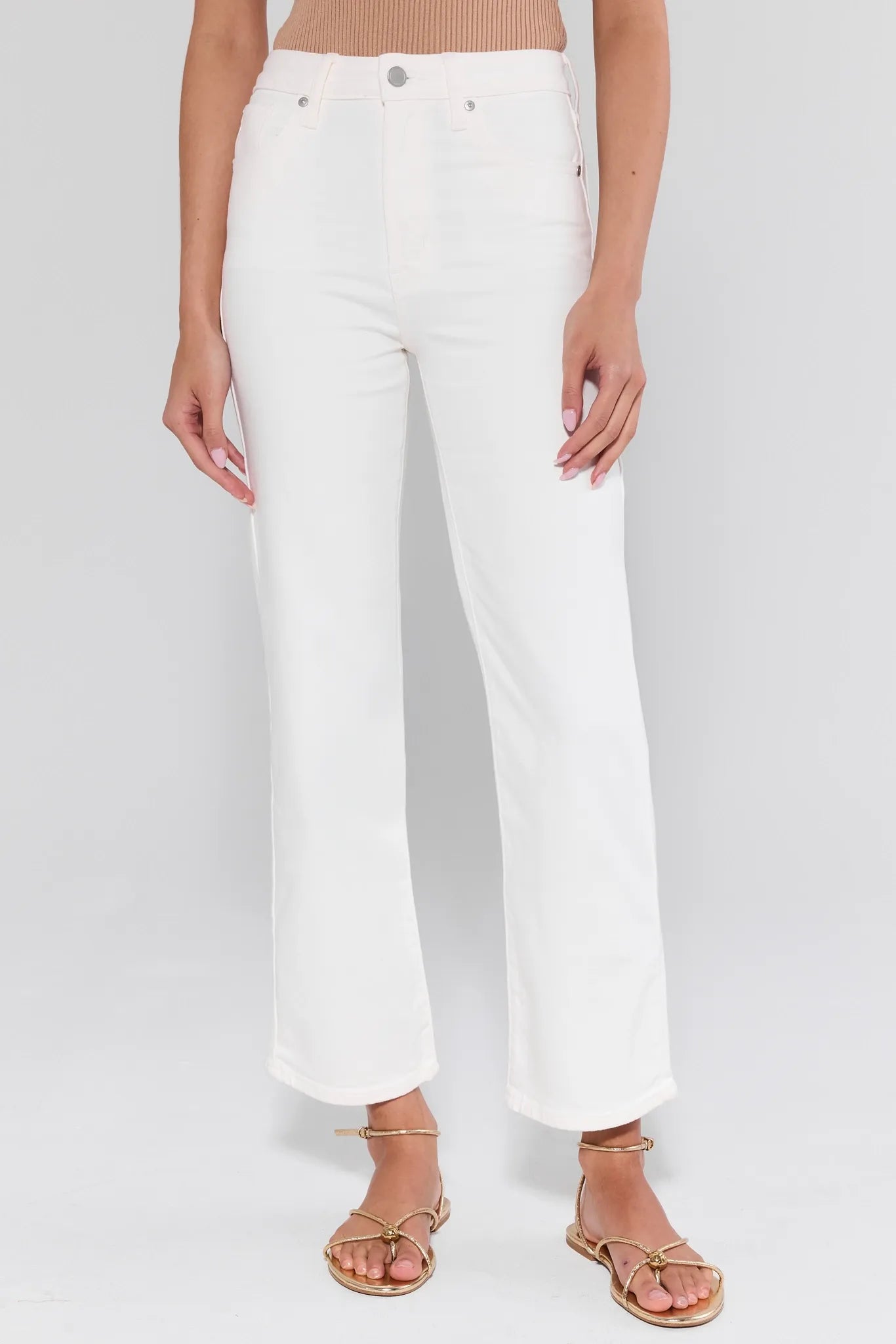 White pants worn by a person on a white background