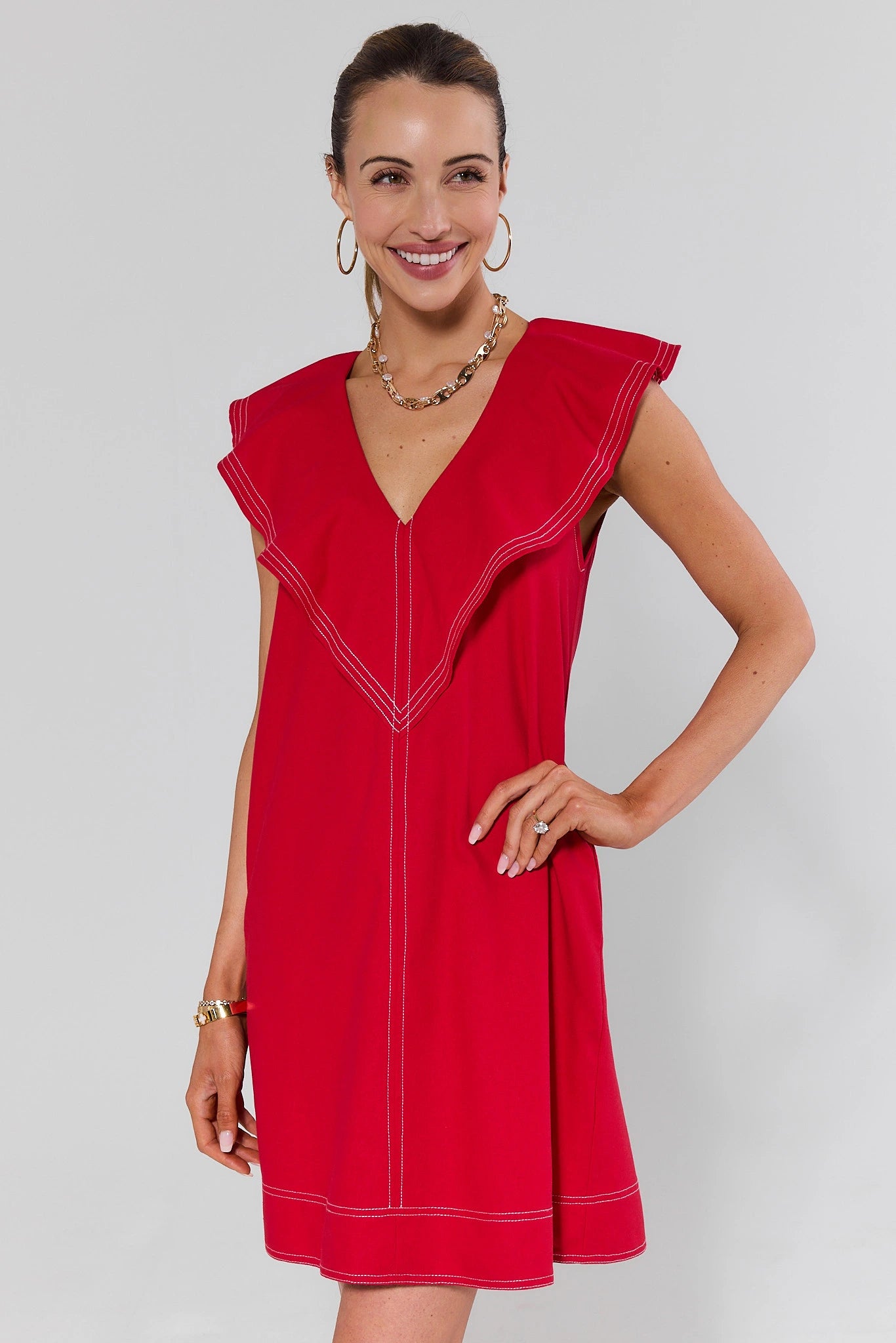 Woman wearing a red dress with a plain background