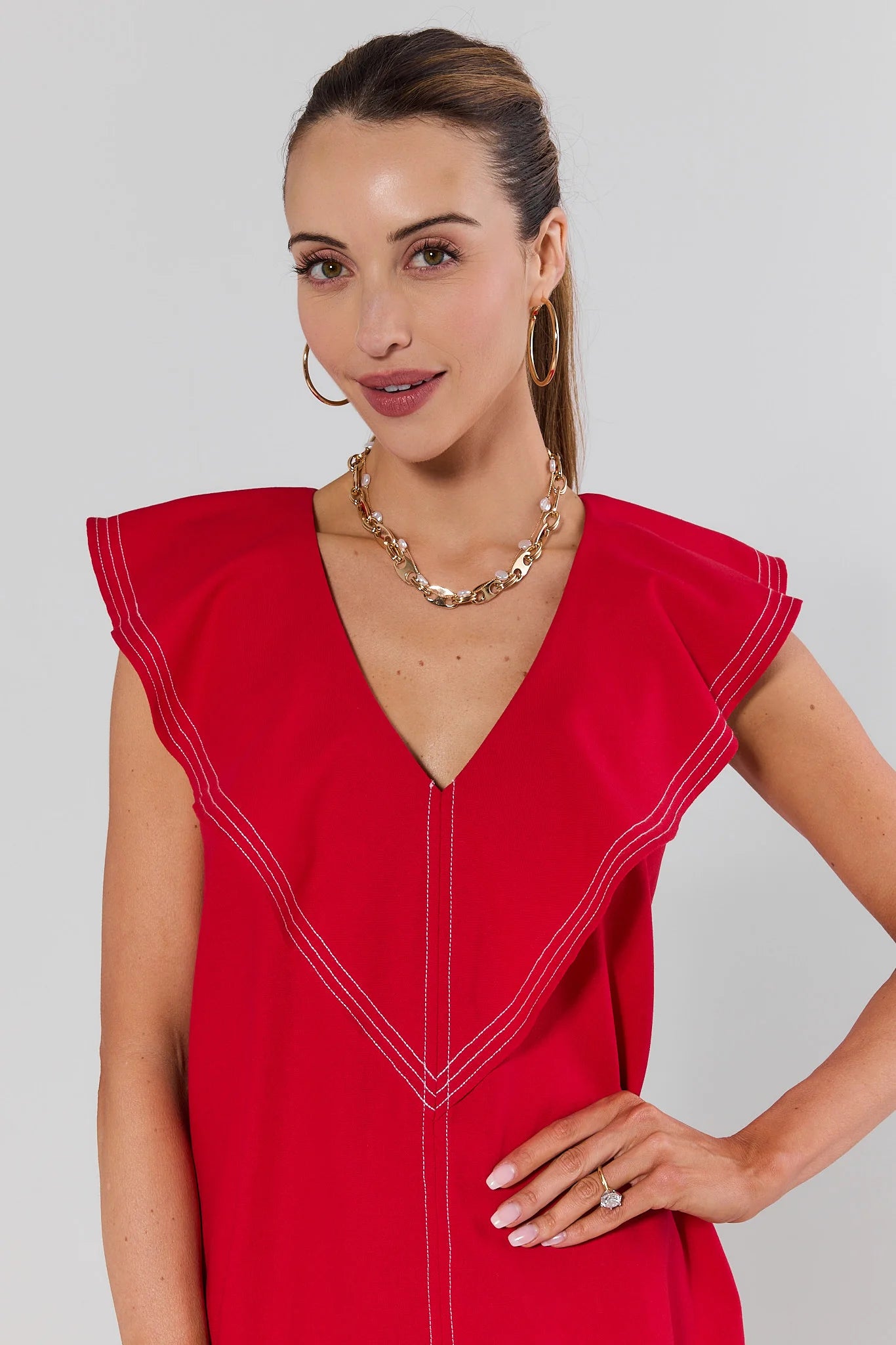 close up Woman wearing a red dress with a plain background