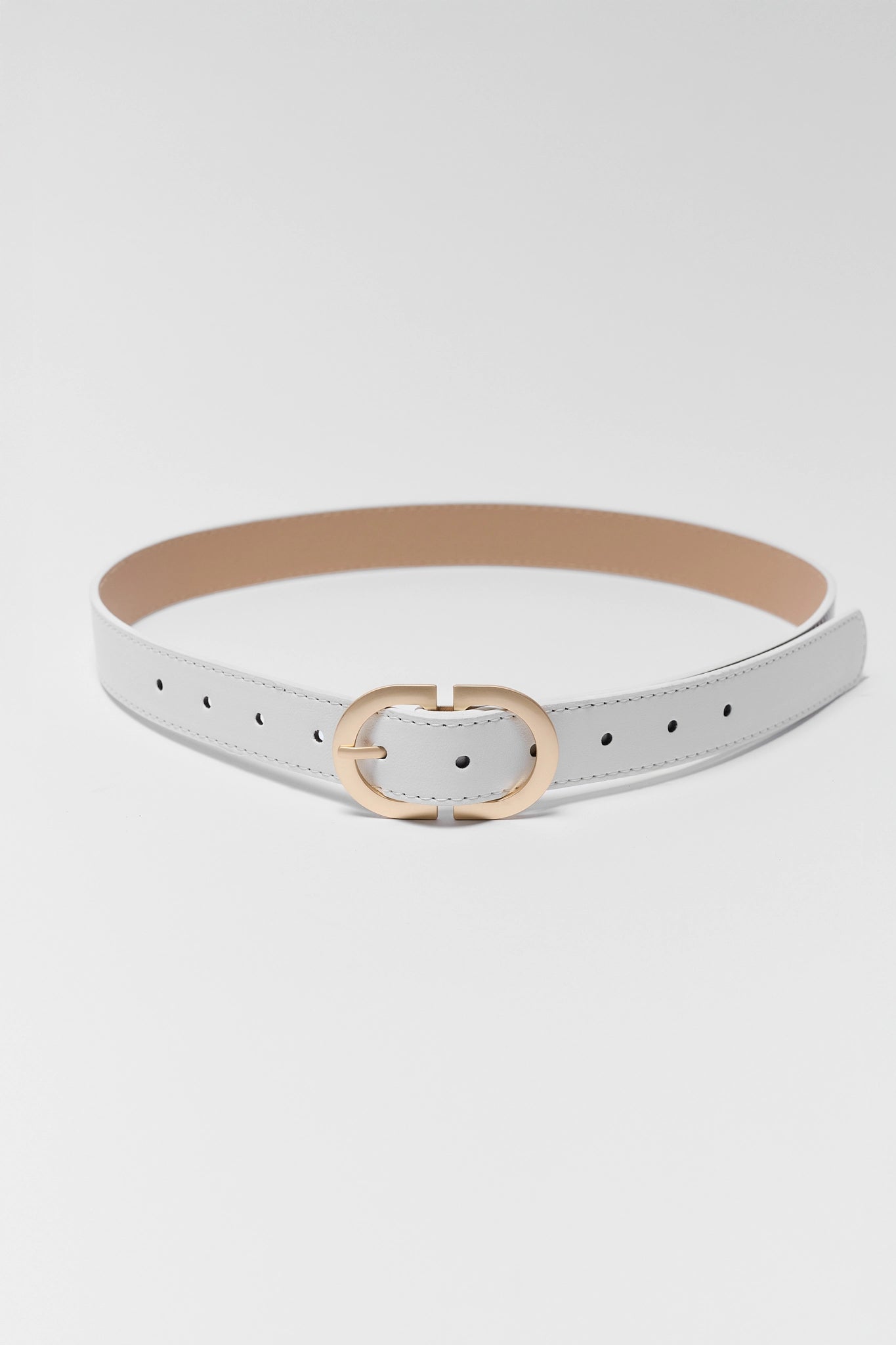 White belt with a gold buckle on a light gray background