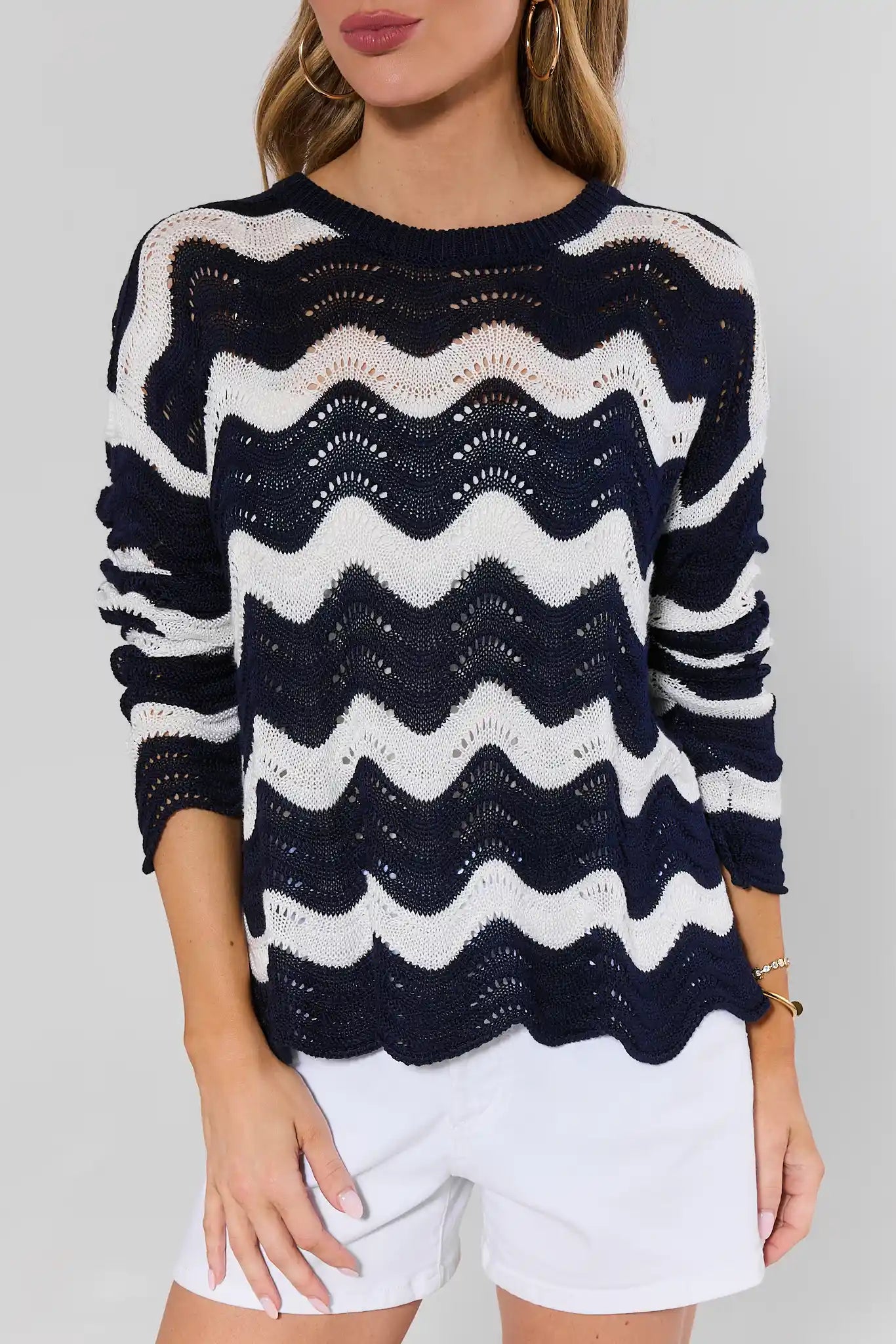 close up Navy and white striped sweater worn by a person on a plain background