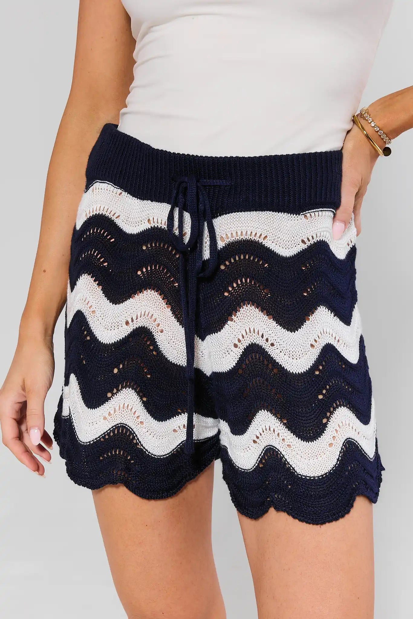 Navy and white patterned shorts worn by a person on a plain background