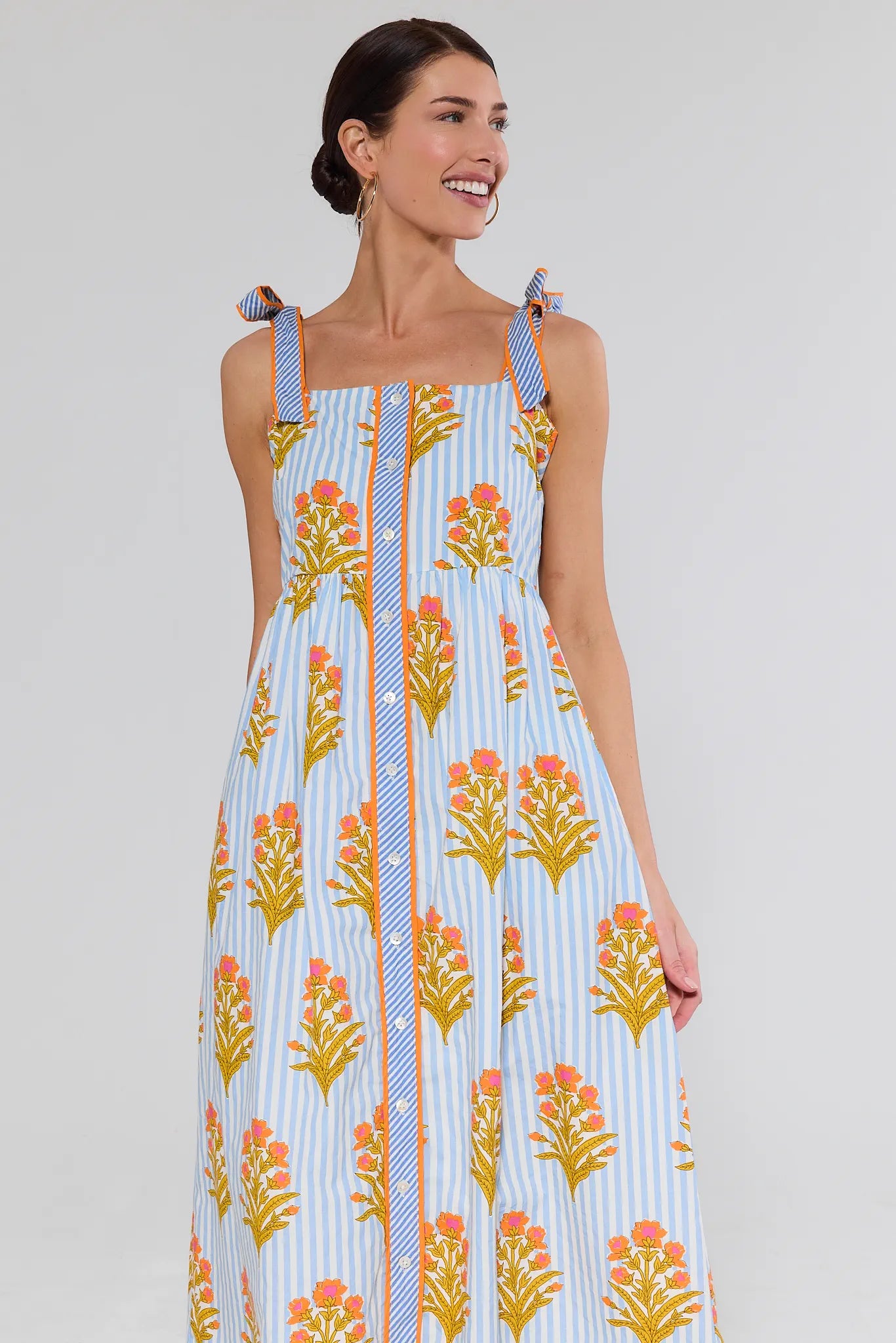 Woman wearing a floral dress with a white background