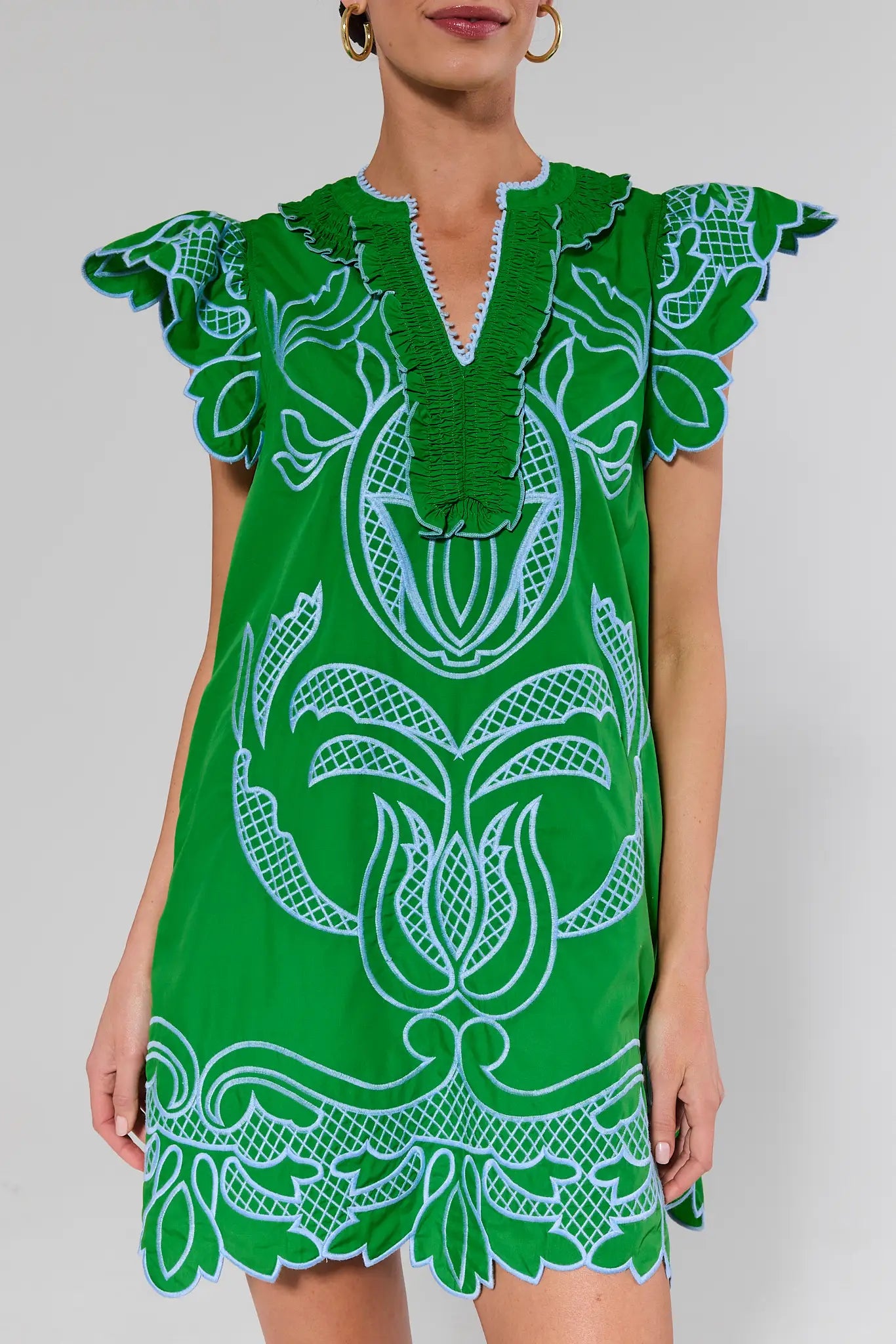 close up Green dress with white patterns on a plain background