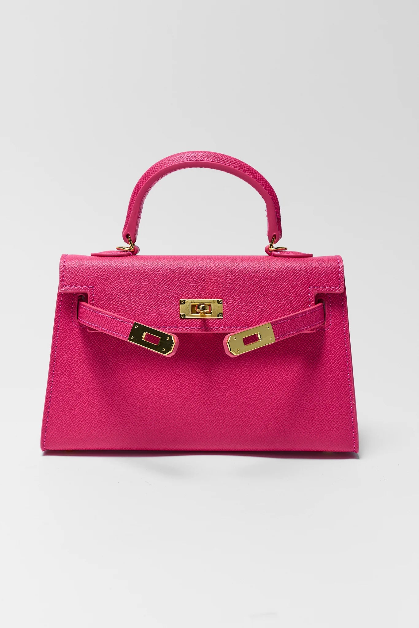 Pink handbag with gold hardware on a white background