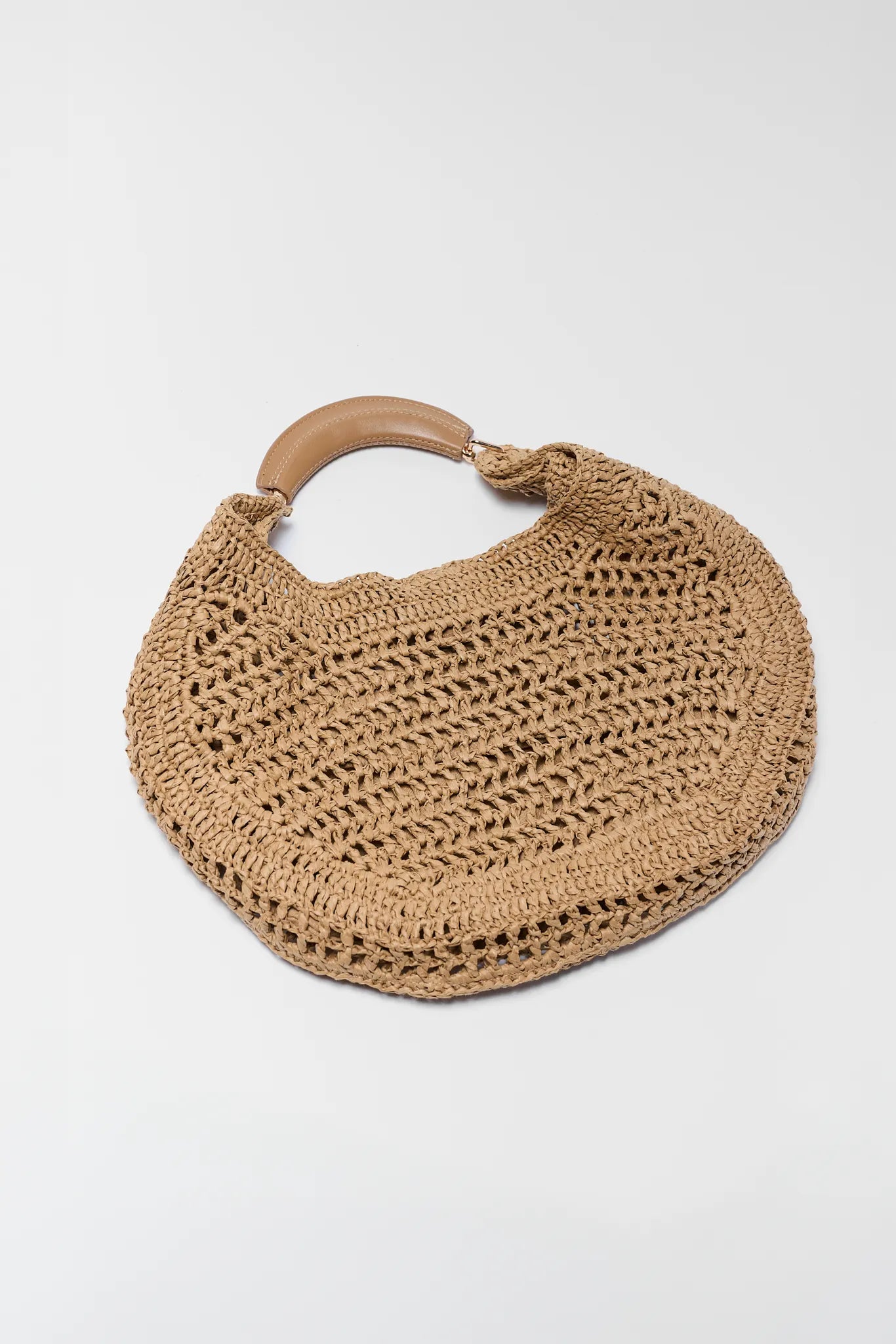 Brown woven handbag with a wooden handle on a white background