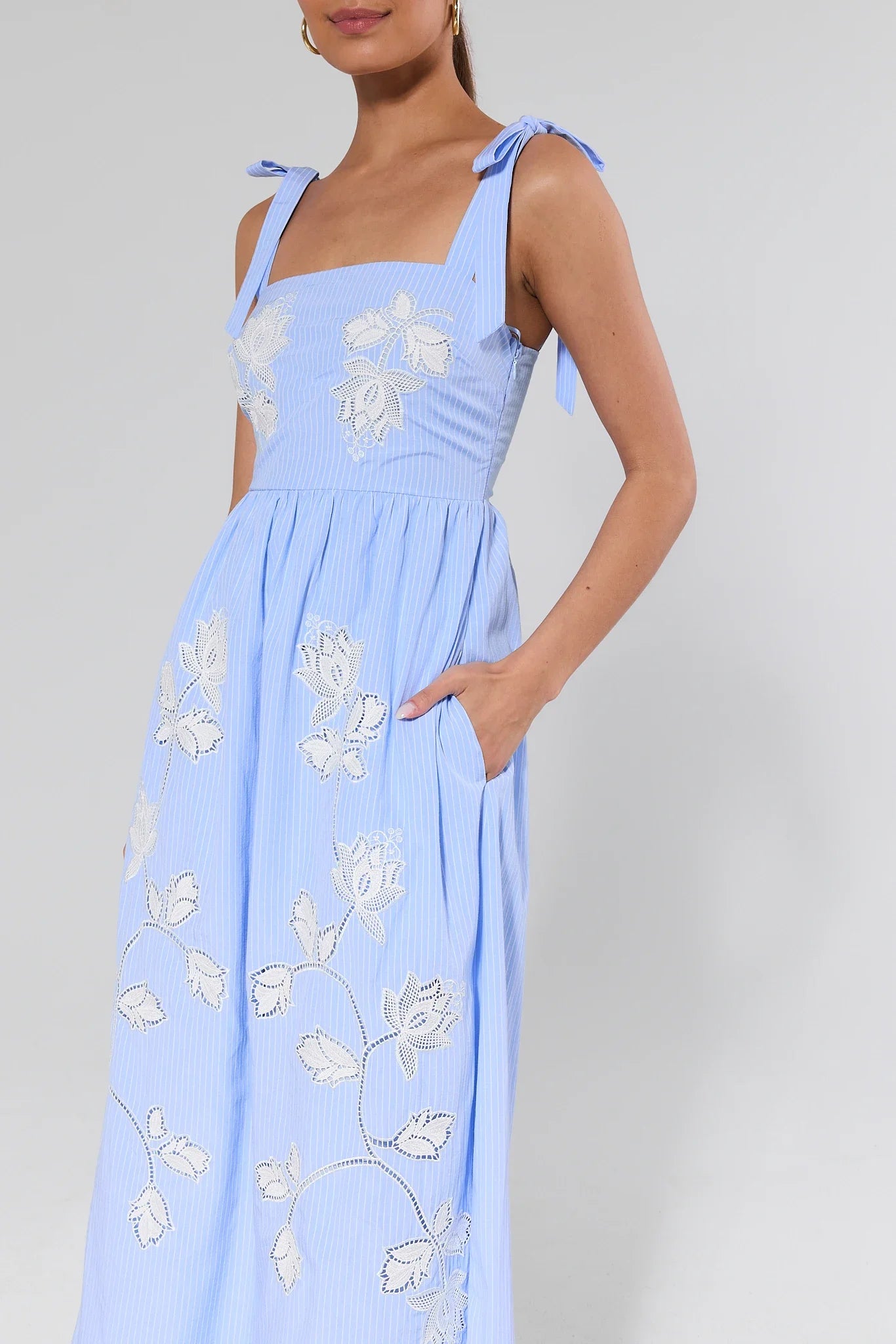Light blue dress with floral patterns on a plain background