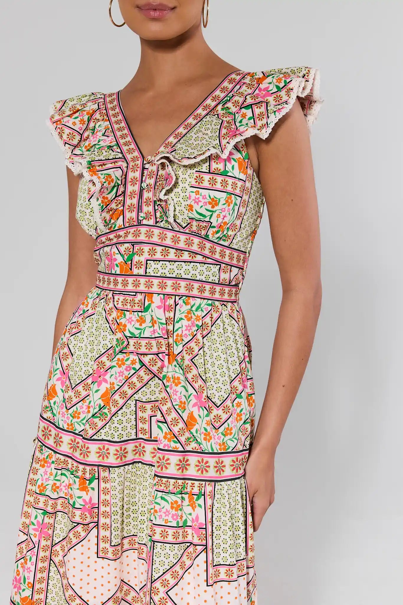 close up Woman wearing a colorful patterned dress on a plain background
