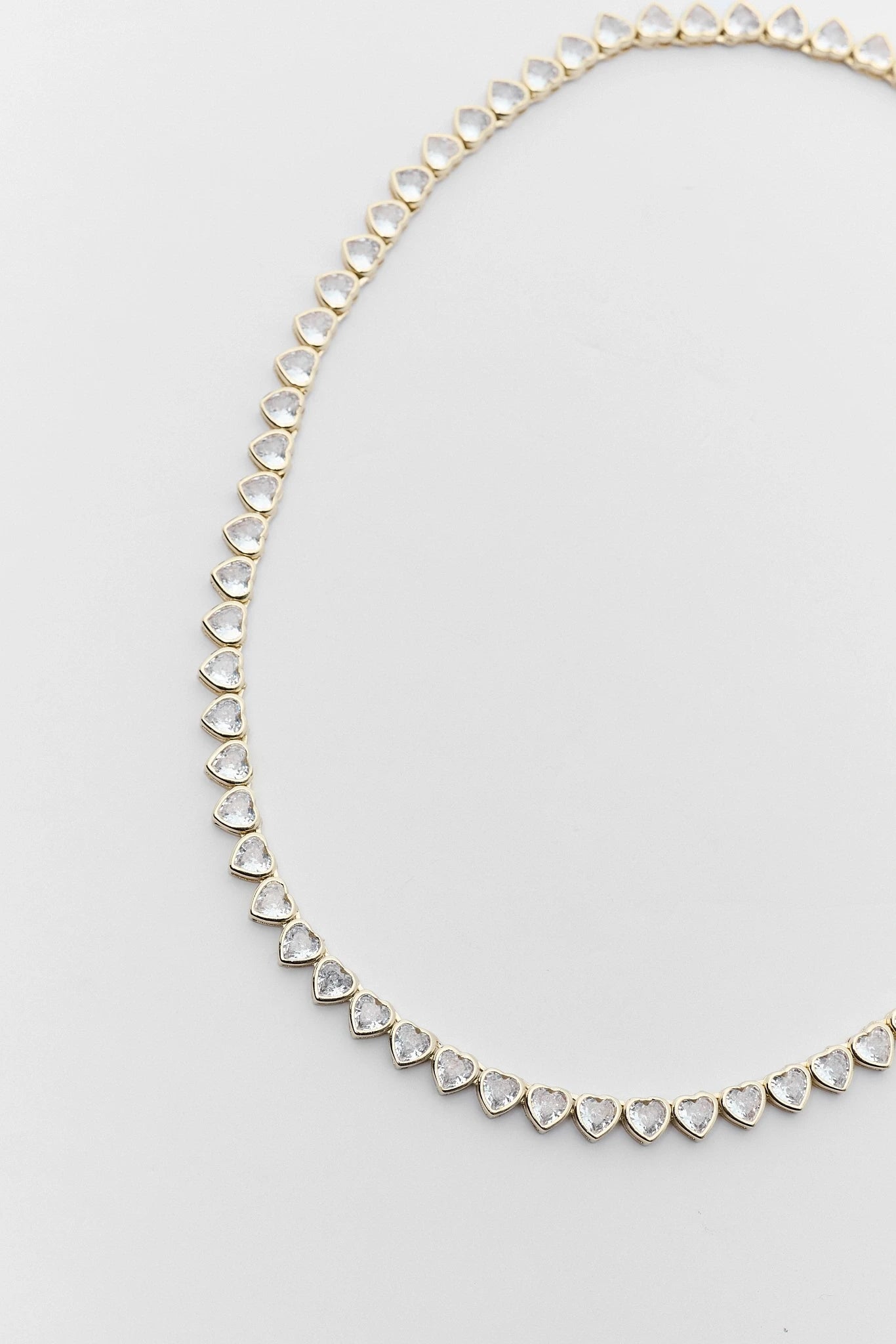 Necklace with heart-shaped gemstones on a light gray background