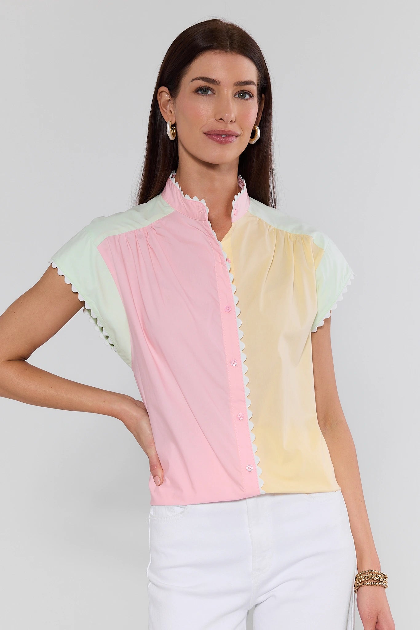 Woman wearing a colorful top with a plain background