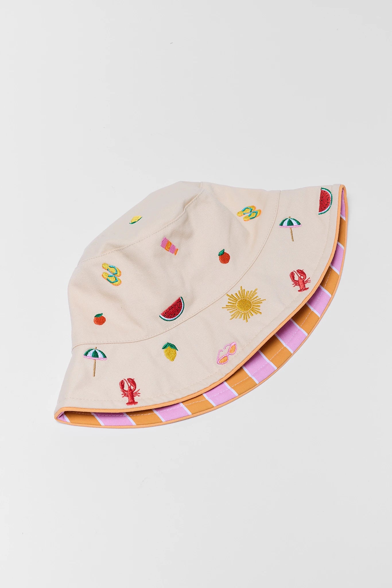 Beige bucket hat with colorful embroidered designs on a white background