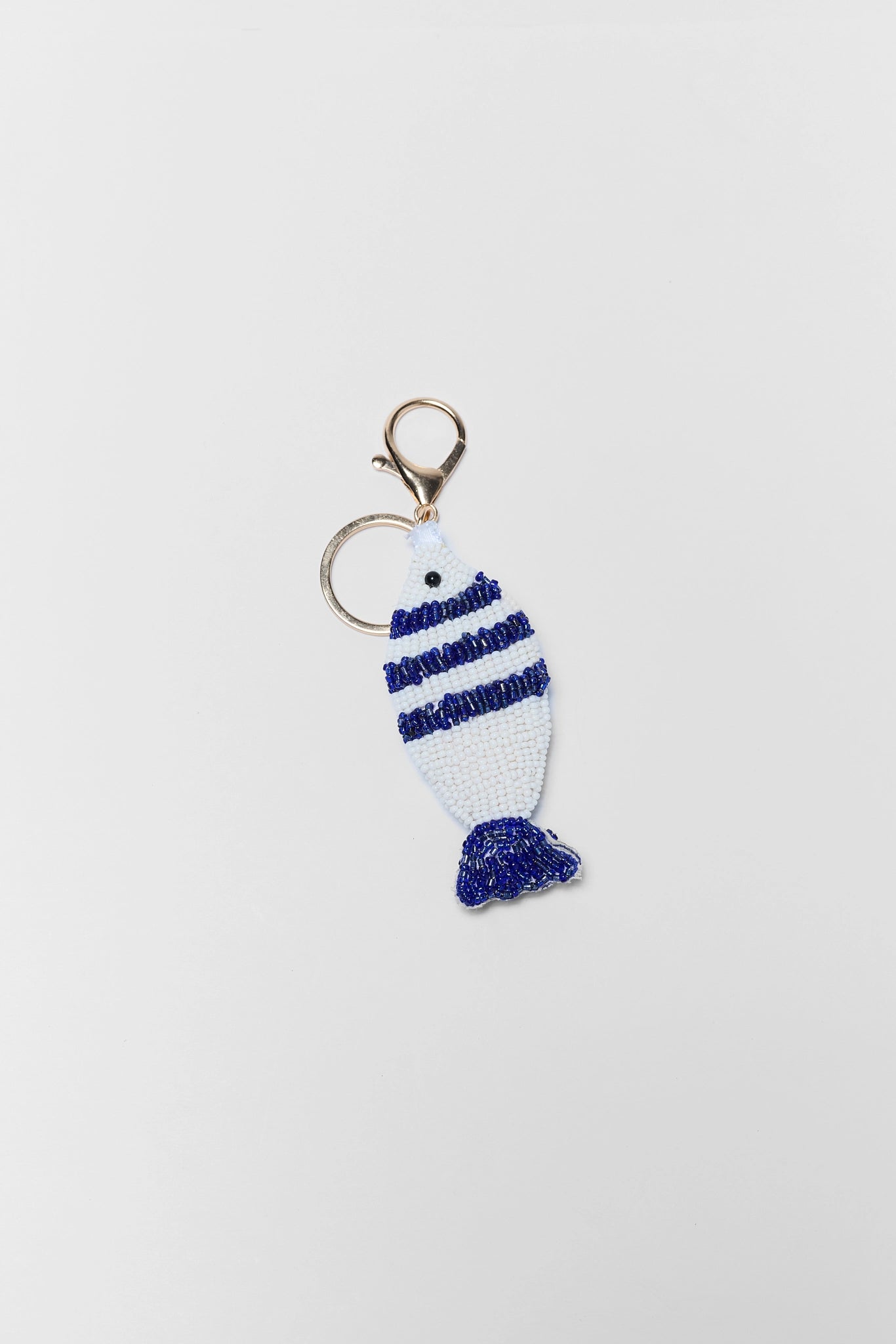 Keychain with blue and white striped design on a light gray background