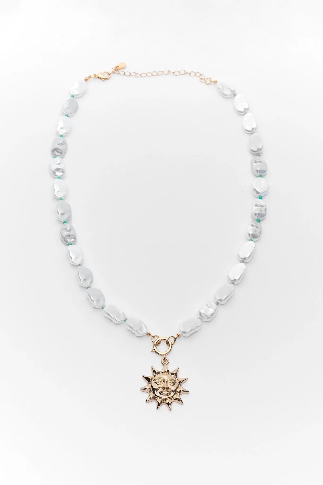 Necklace with sun pendant on a white background