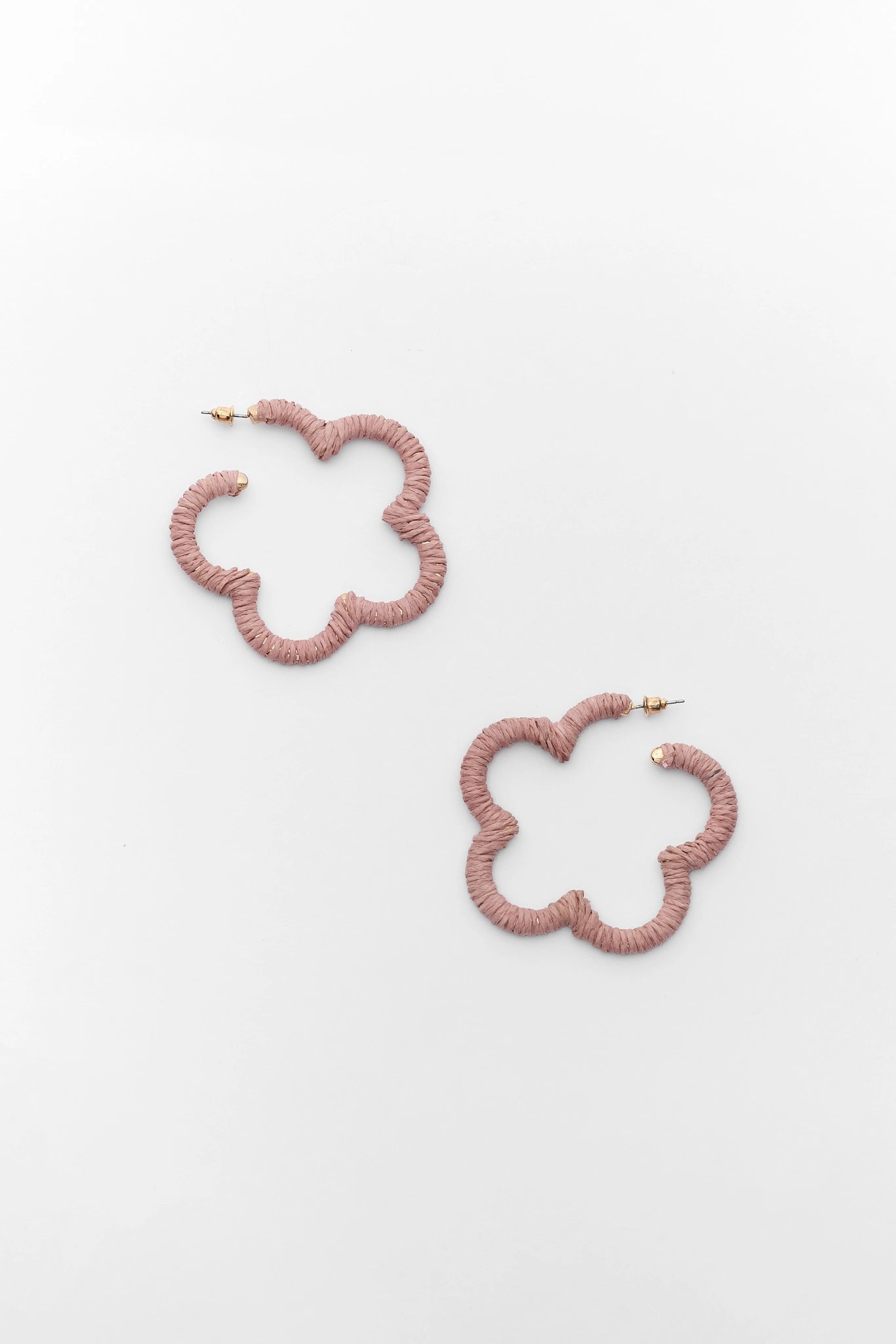 Pair of pink floral hoop earrings on a light gray background