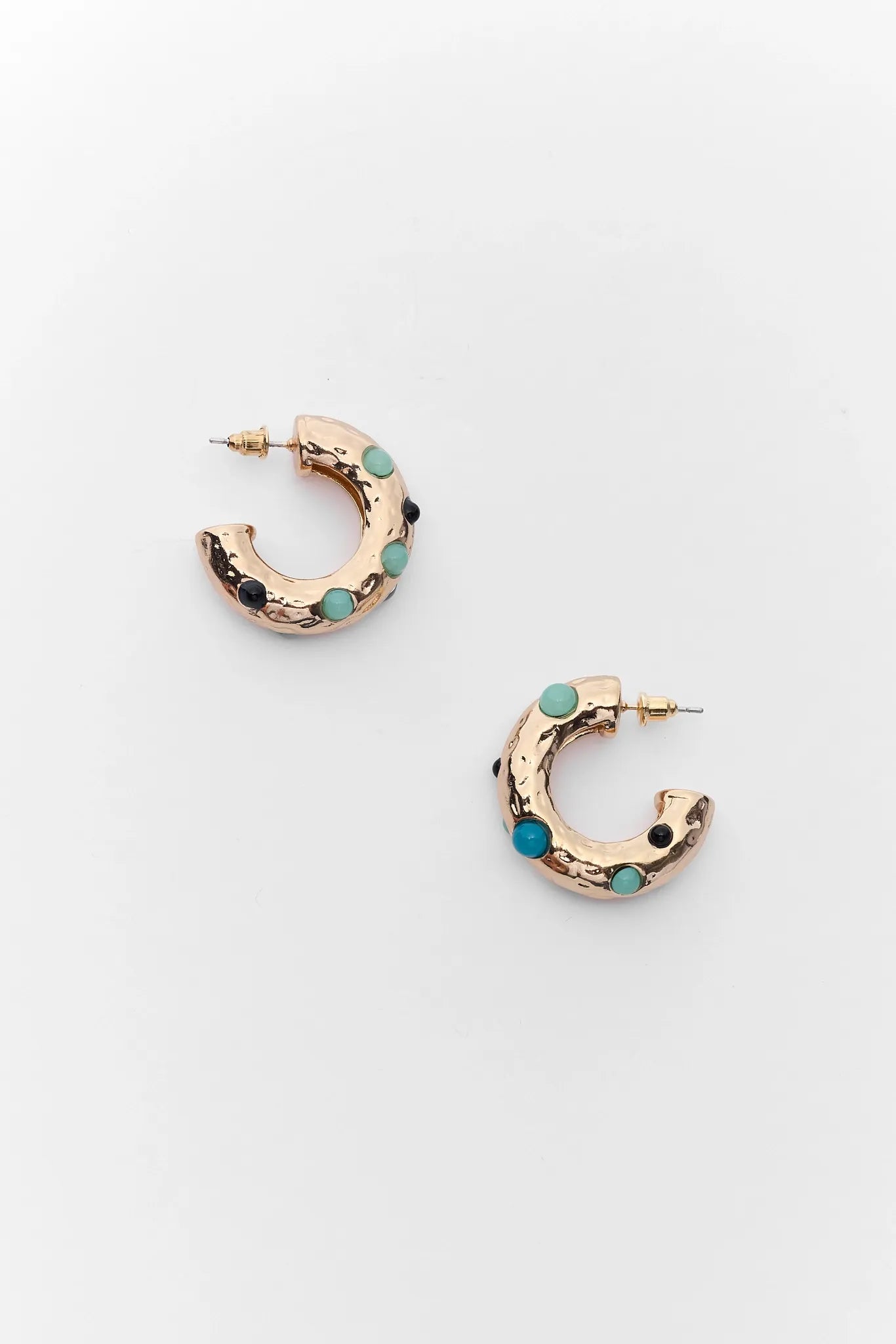 Gold hoop earrings with turquoise stones on a white background
