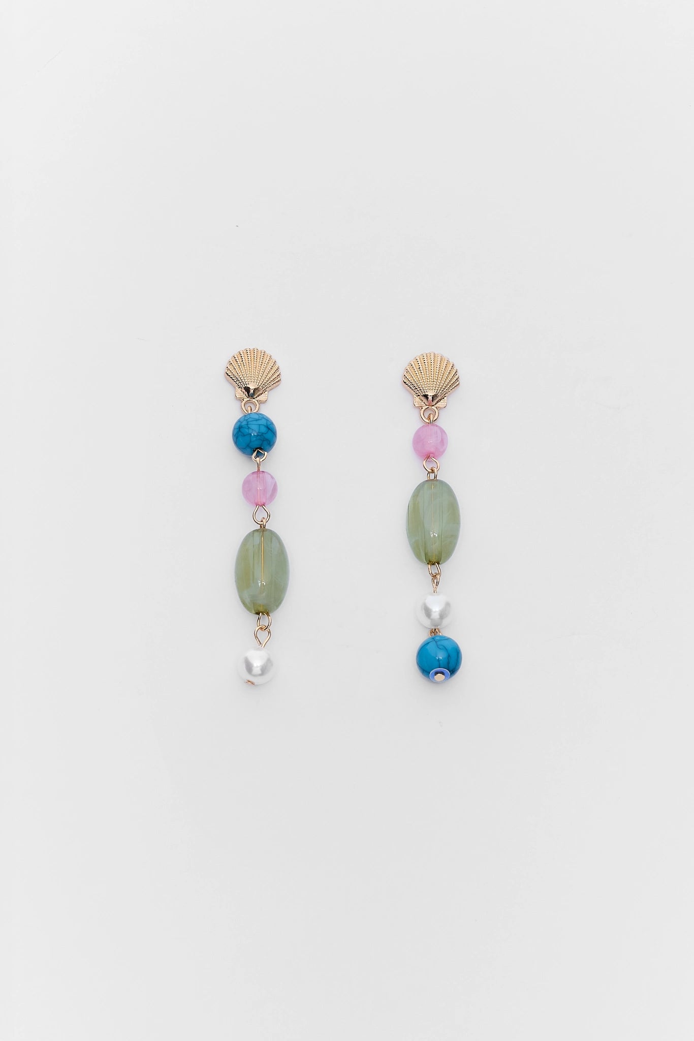 Pair of earrings with colorful beads on a light gray background