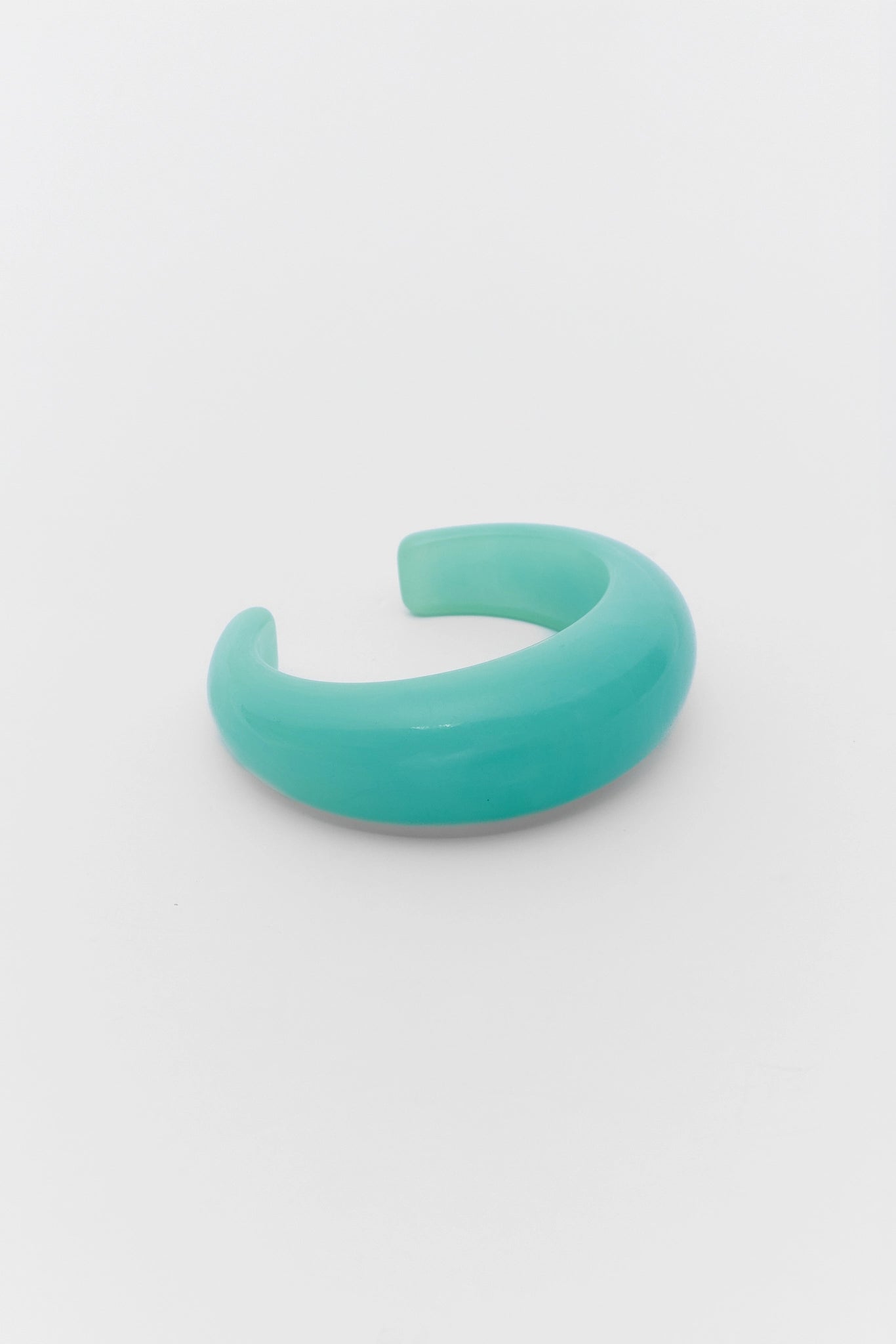 Turquoise bracelet on a white plain background