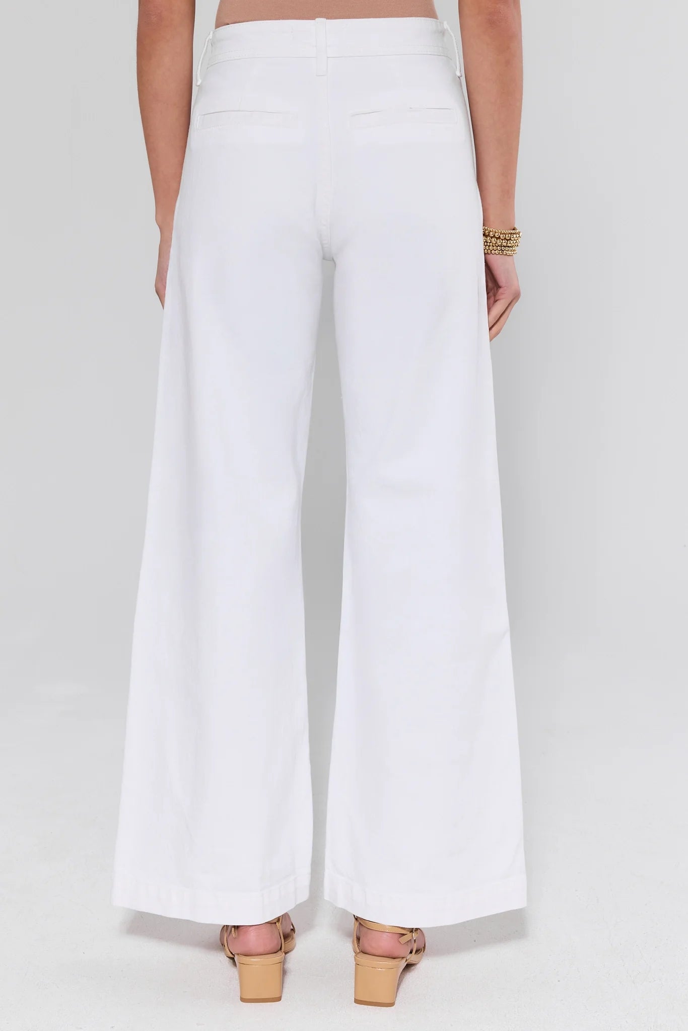 White wide-leg pants worn by a person on a plain background