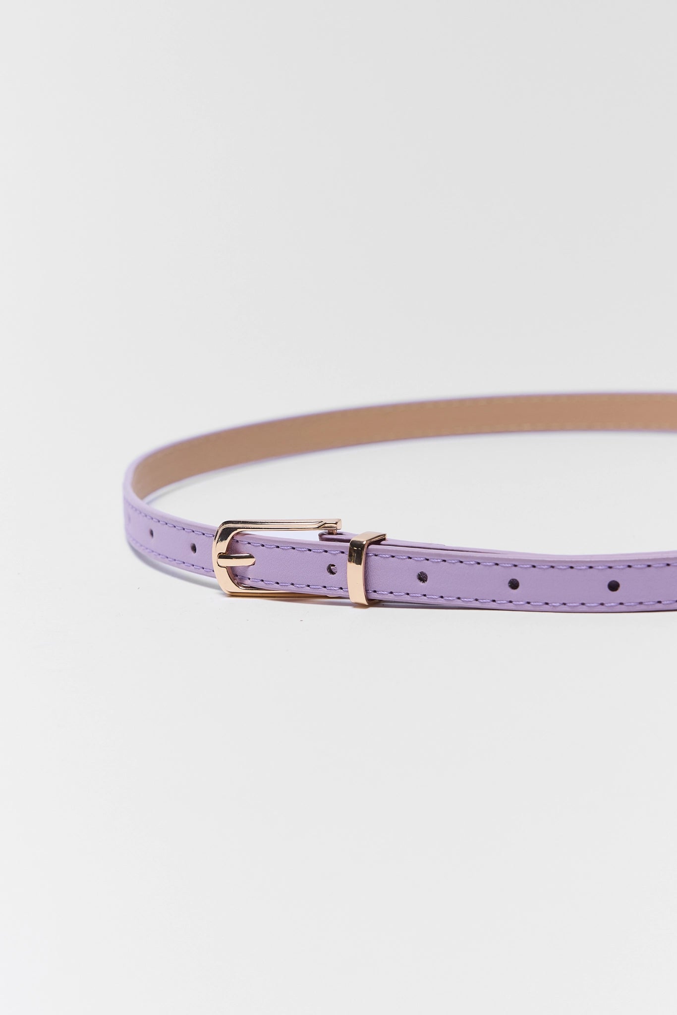 close up of Lavender Faux Leather Skinny Belt on white background