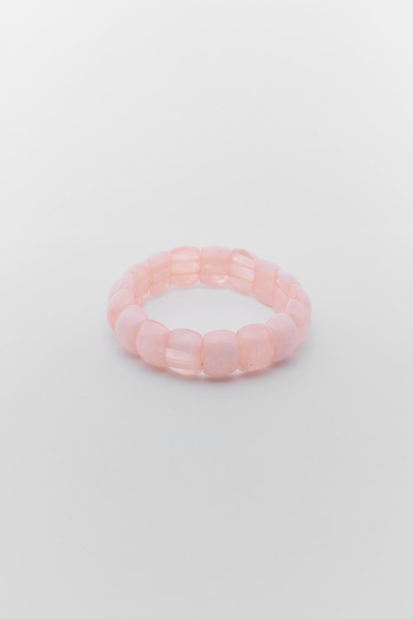 Pink beaded bracelet on a light gray background