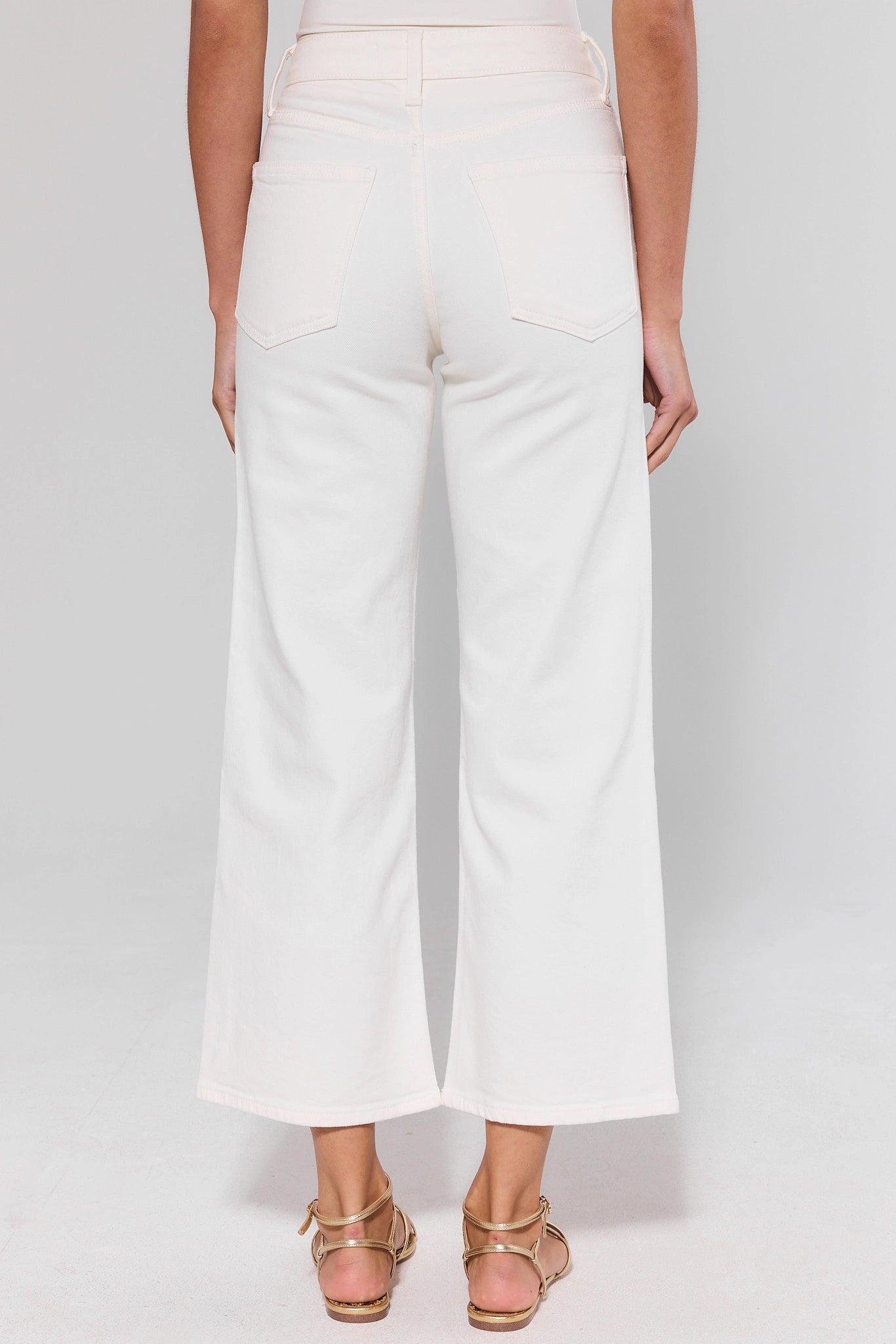 standing White wide-leg pants worn by a person on a plain background