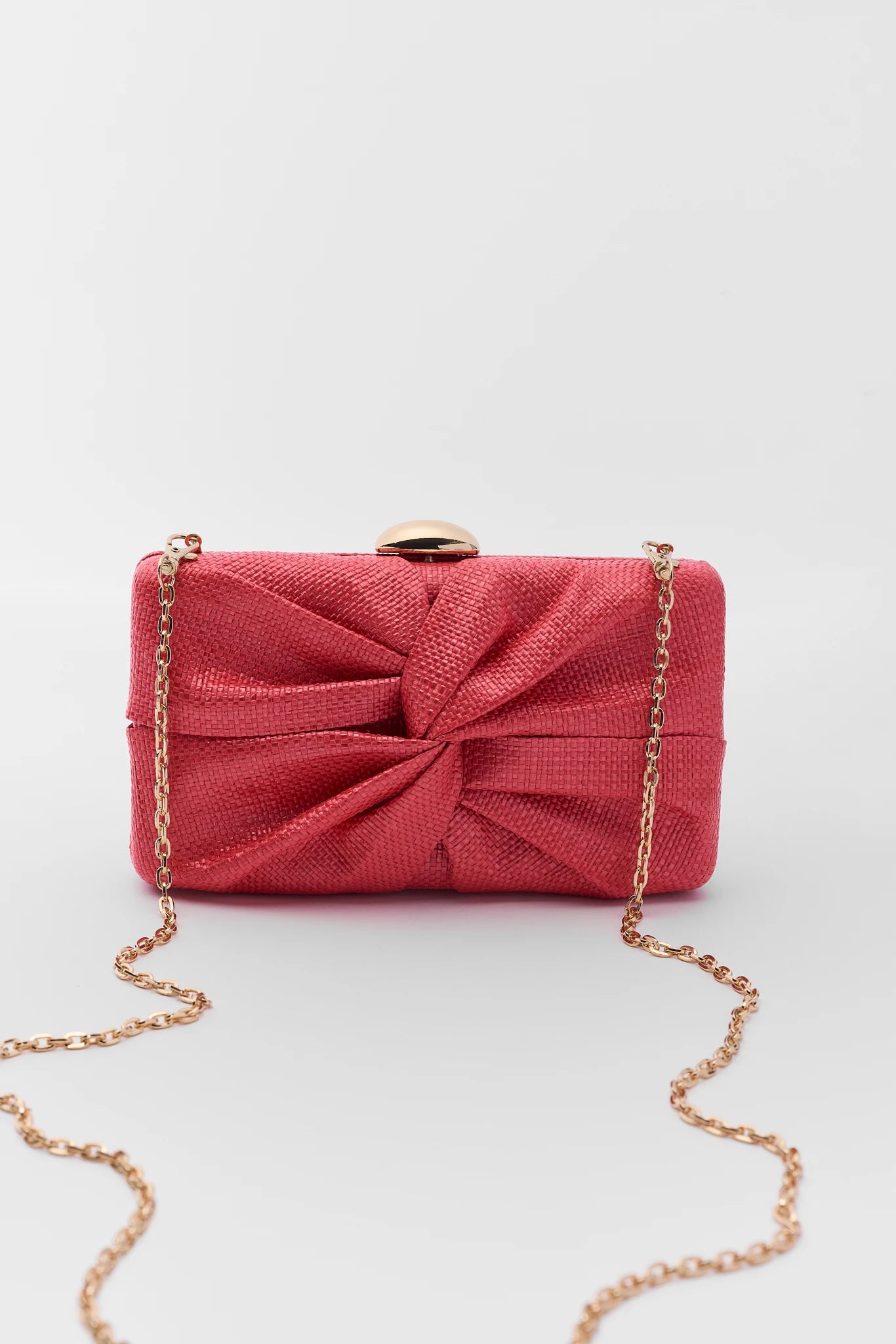 Red clutch bag with a gold chain on a white background