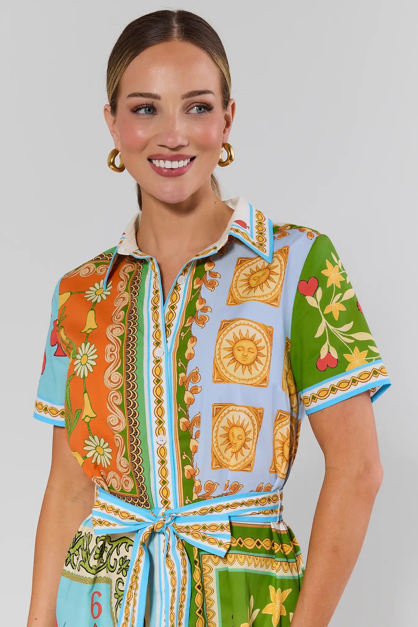 close up Woman wearing a colorful patterned dress on a plain background