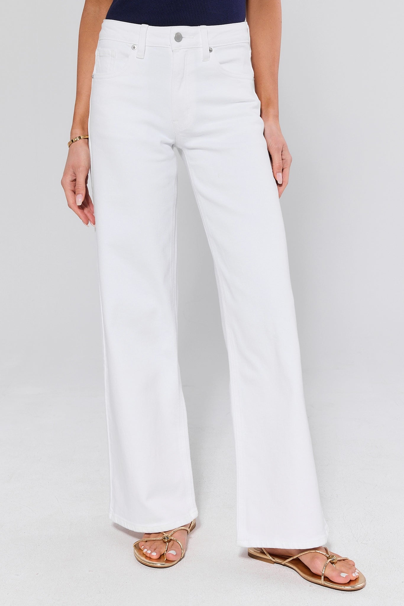 White jeans worn by a person on a white background