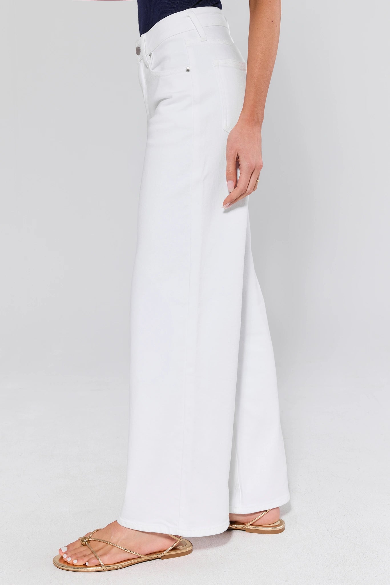 side shot White wide-leg pants worn by a person on a white background