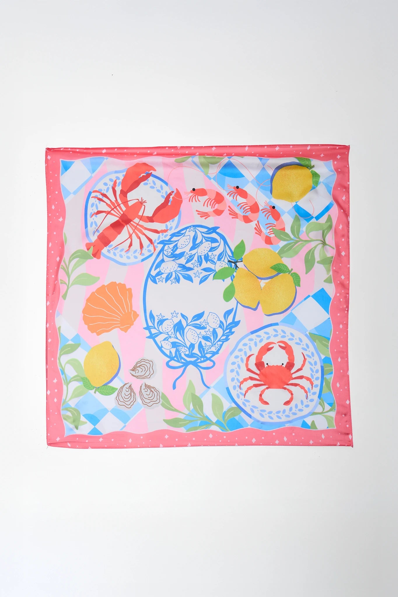 Colorful fabric square with crab, lemon, and shell pattern on a white background