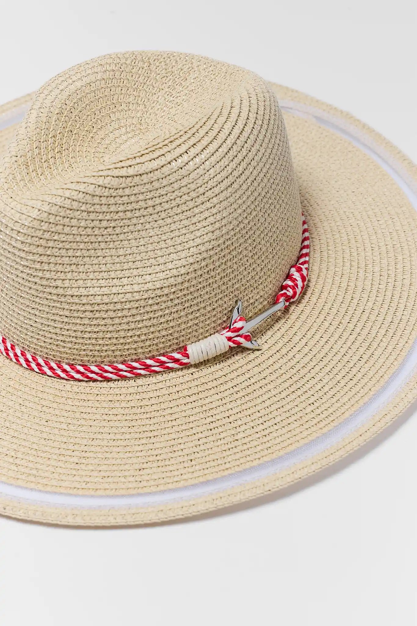 Beige straw hat with a red and white striped band on a light gray background