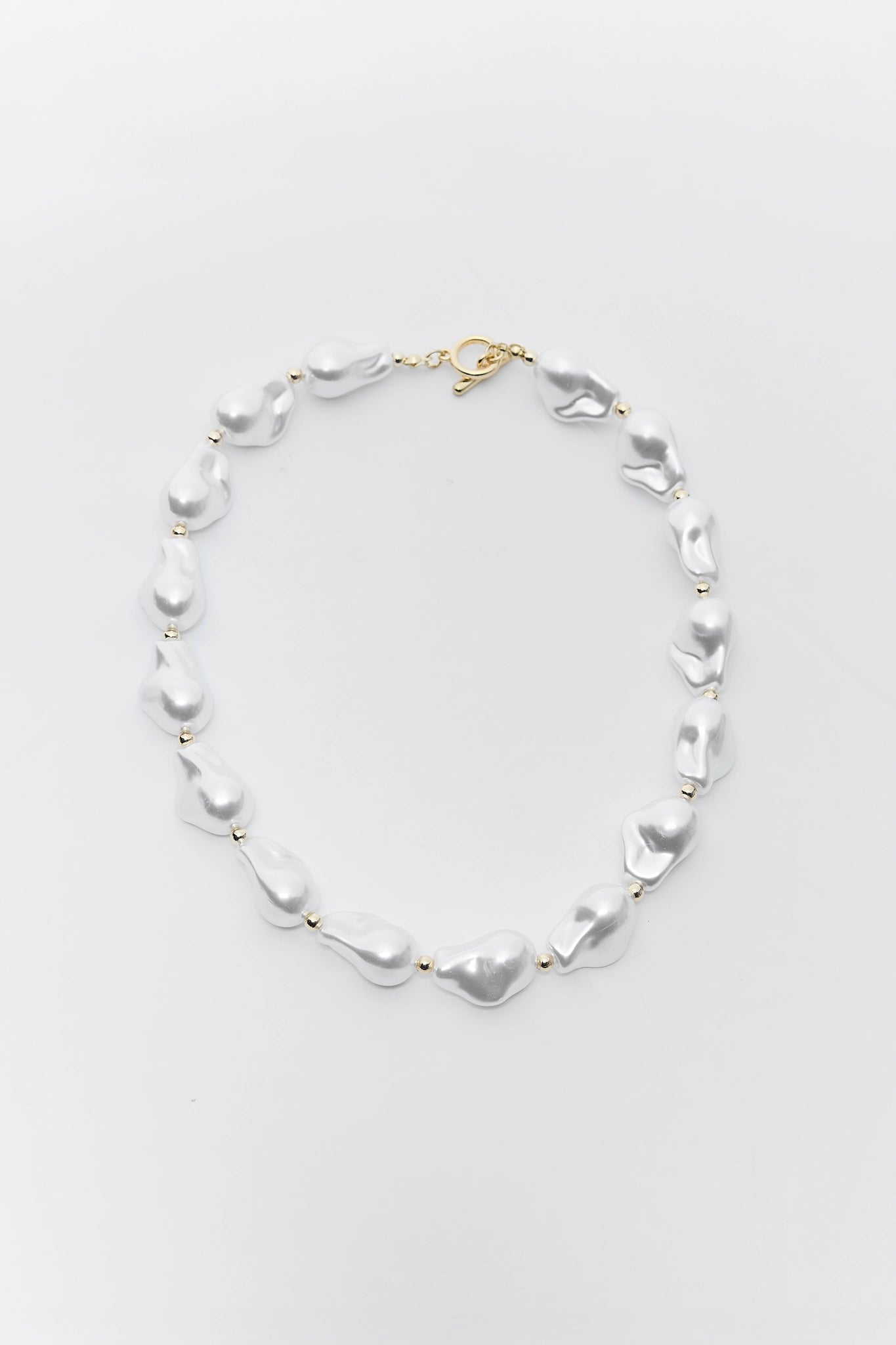 Pearl necklace on a light gray background