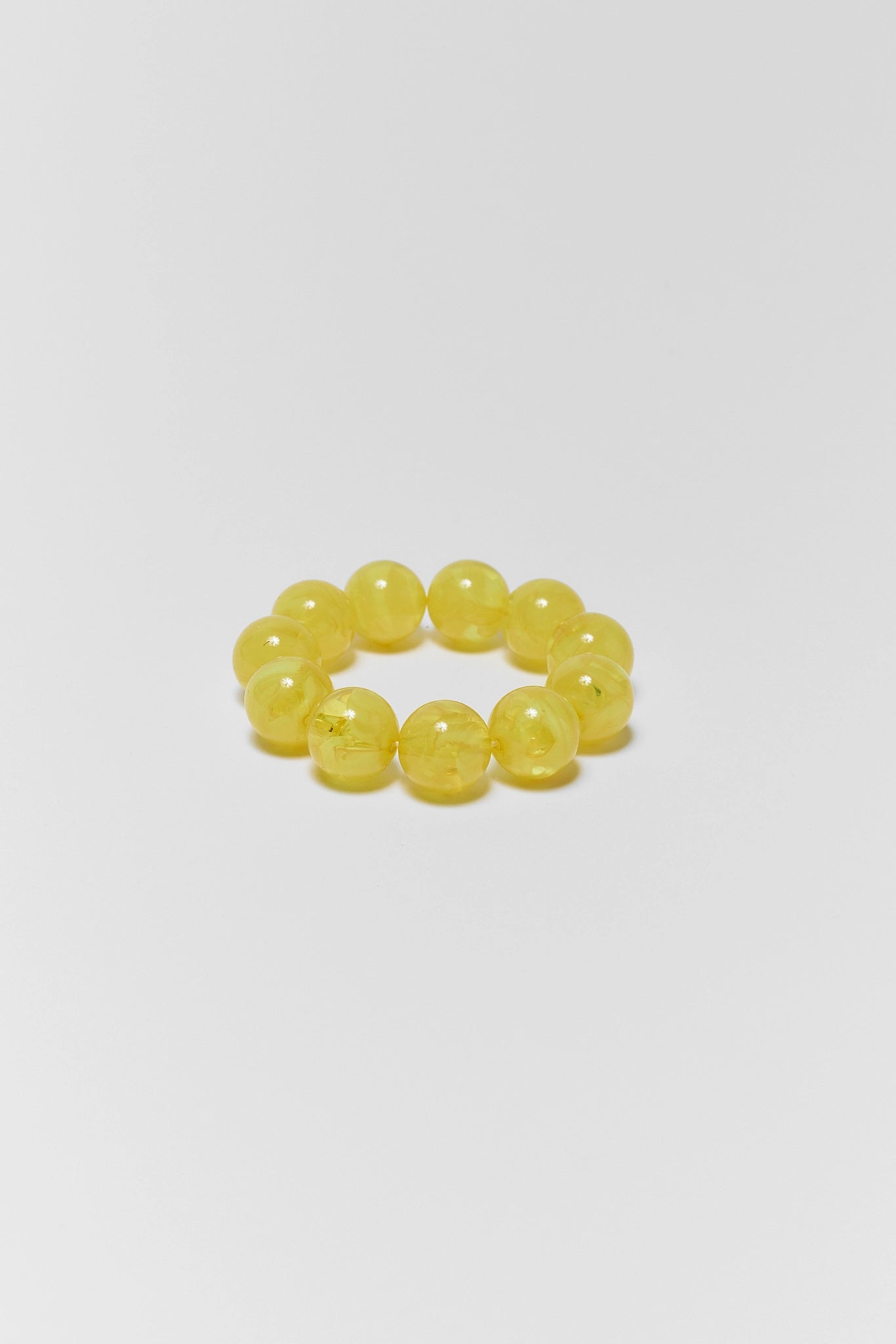Yellow beaded bracelet on a light gray background