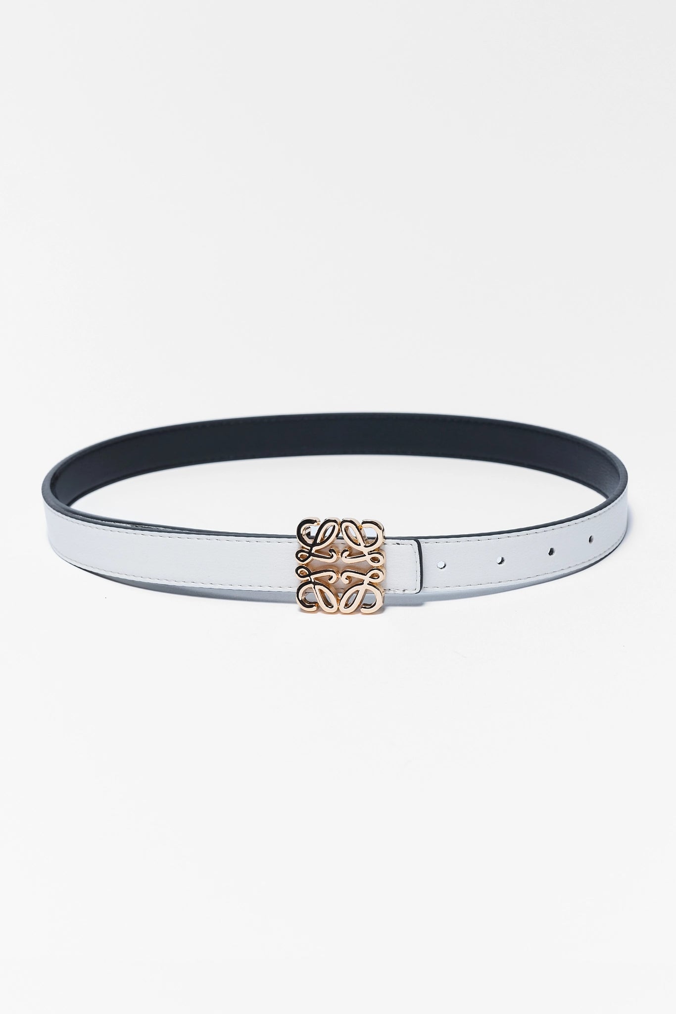 White belt with a gold buckle on a light gray background