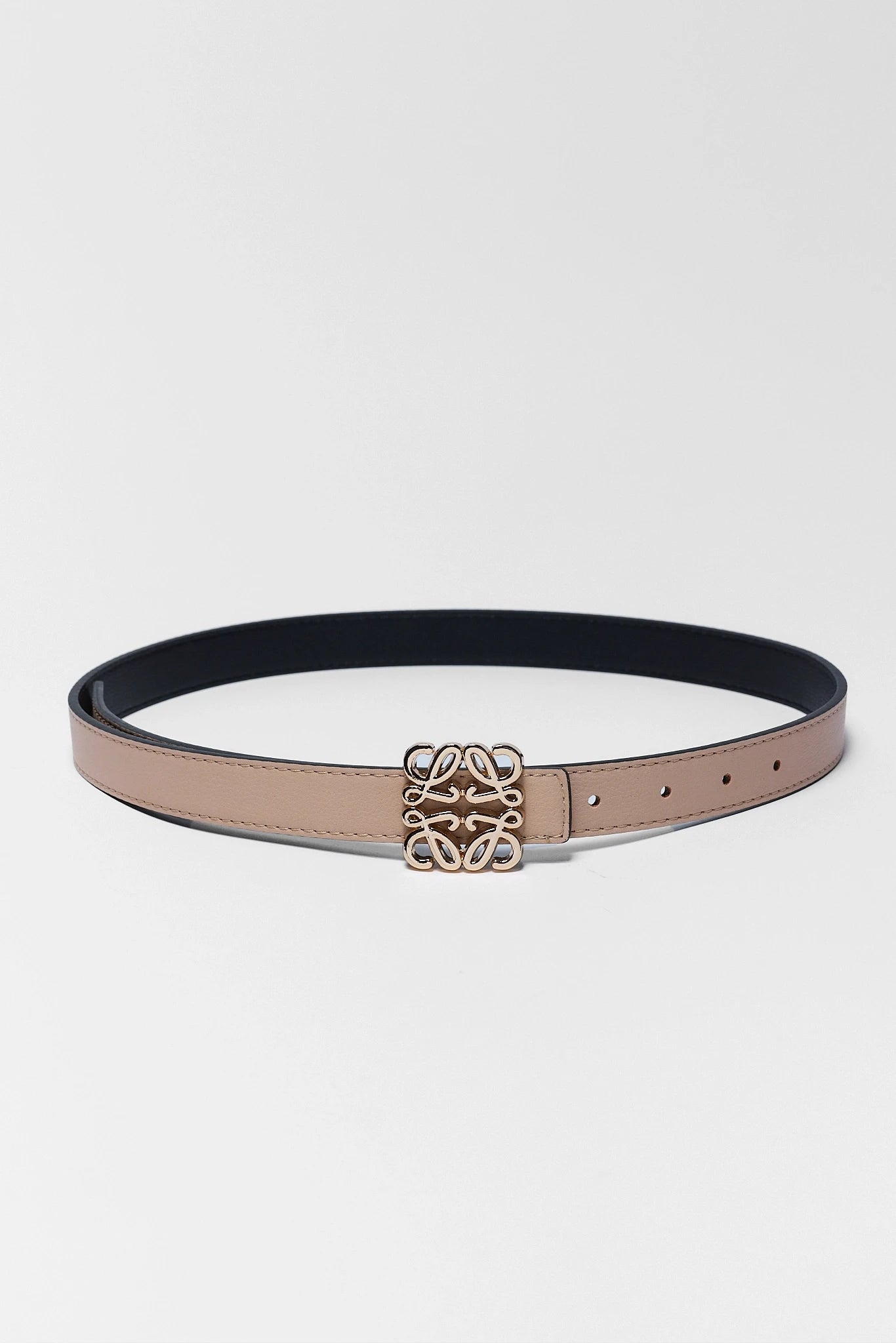 Belt with a gold logo on a white background