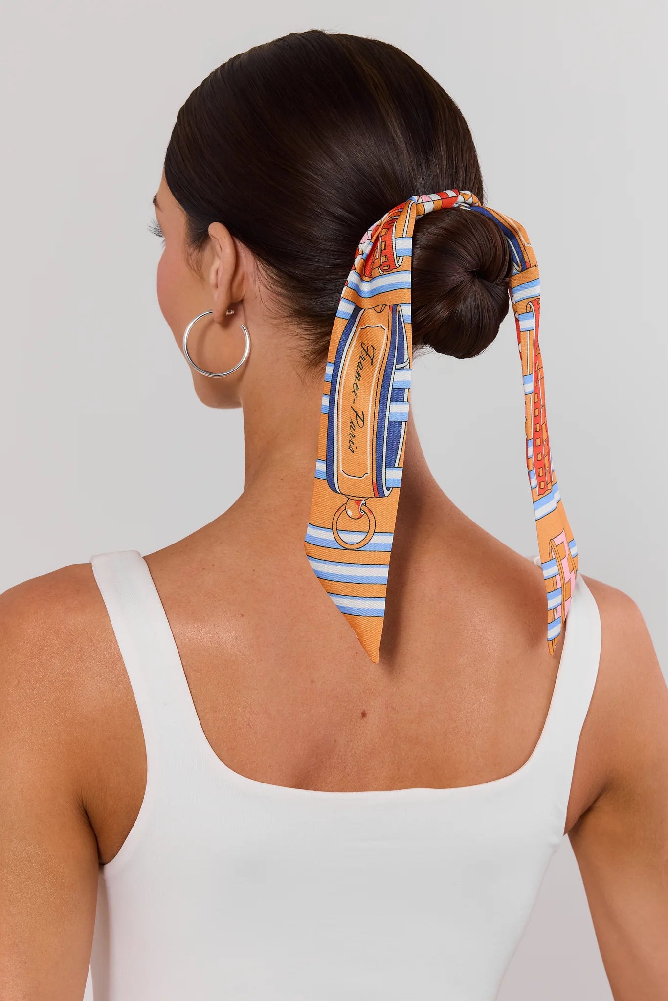 woman wearing orange scarf in hair