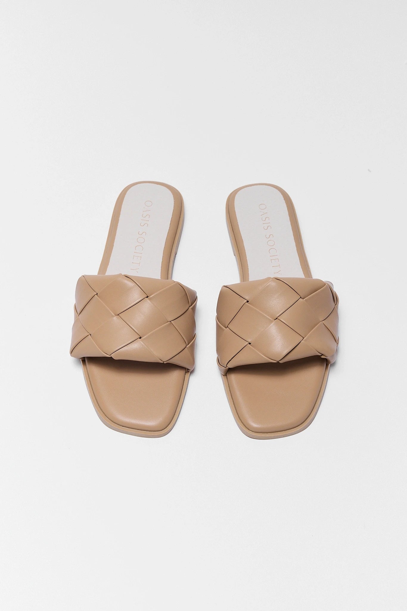 Pair of two beige woven sandals on a white background