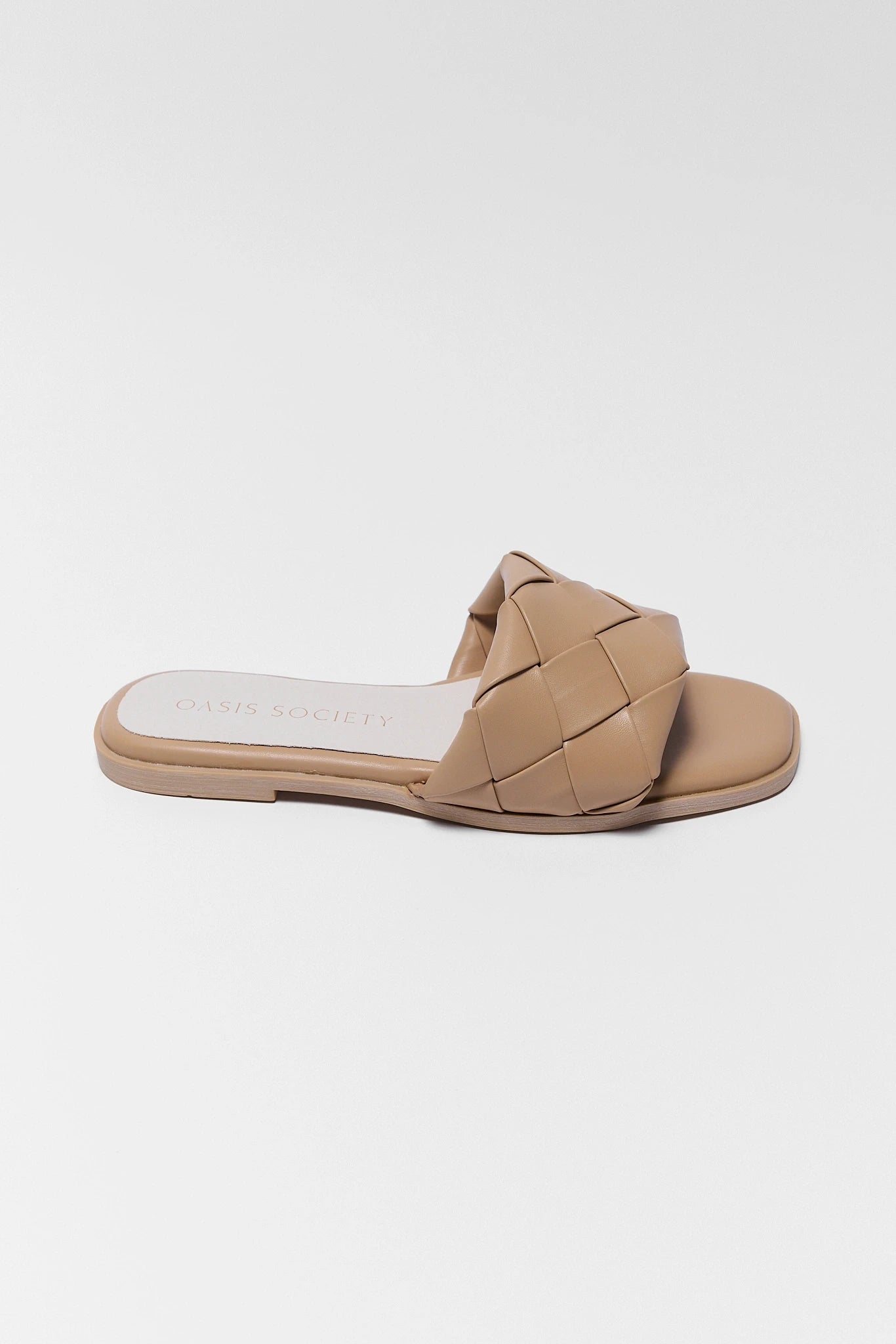 Beige sandal with woven design on a white background one