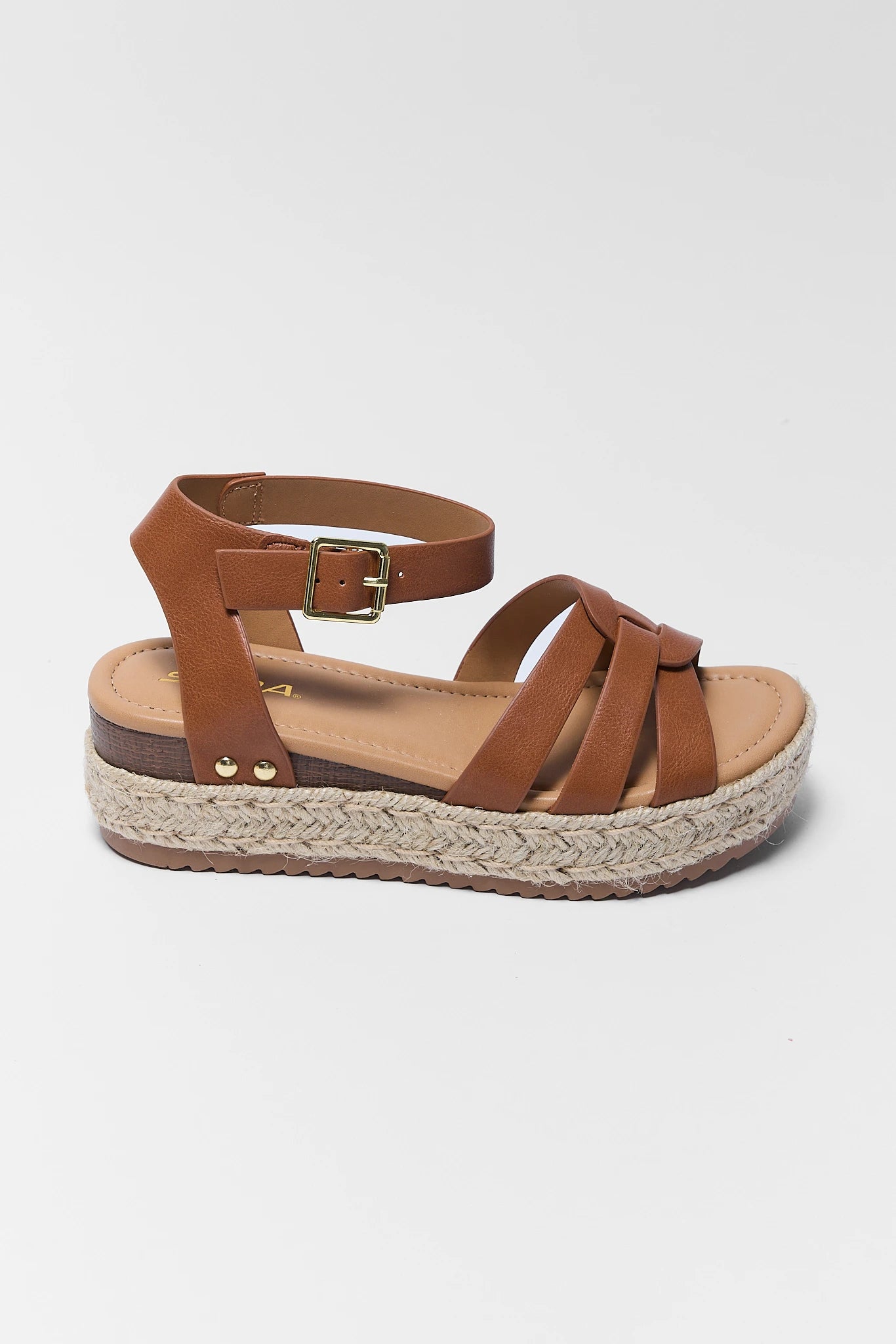 Brown sandal with espadrille sole on a light gray background one