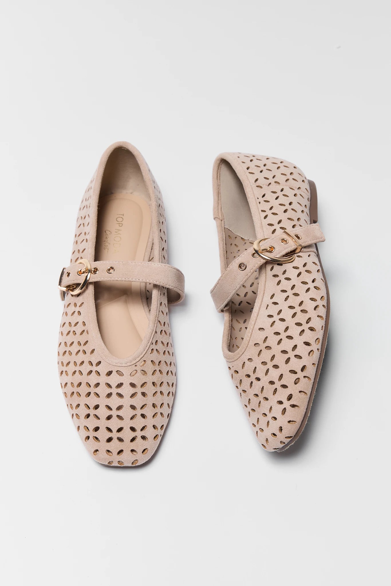 A pair of beige openwork leather Mary Jane flats with square toes and buckle straps, displayed on a clean white background.