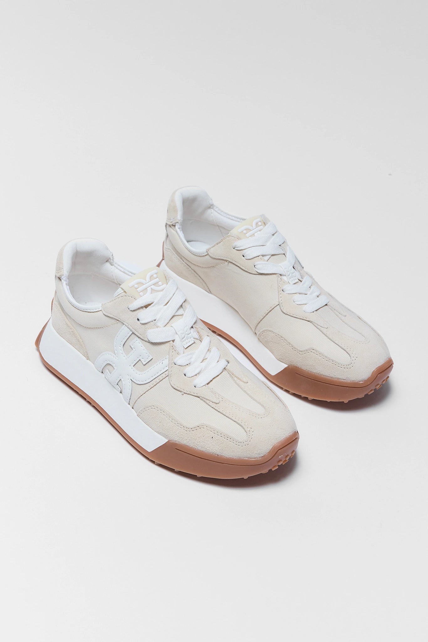 two langley ivory sneakers by sam edleman on white background
