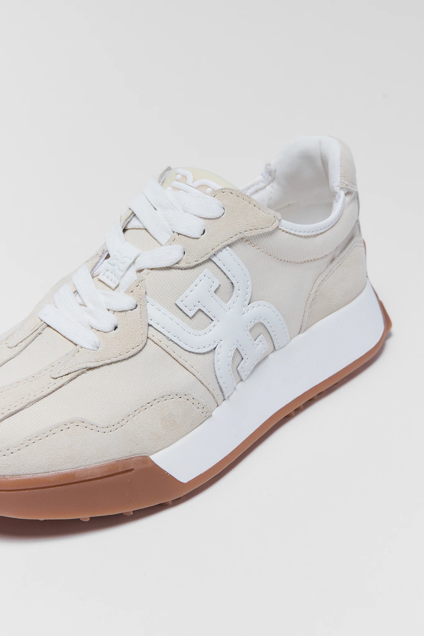 close up langley ivory sneakers by sam edleman on white background